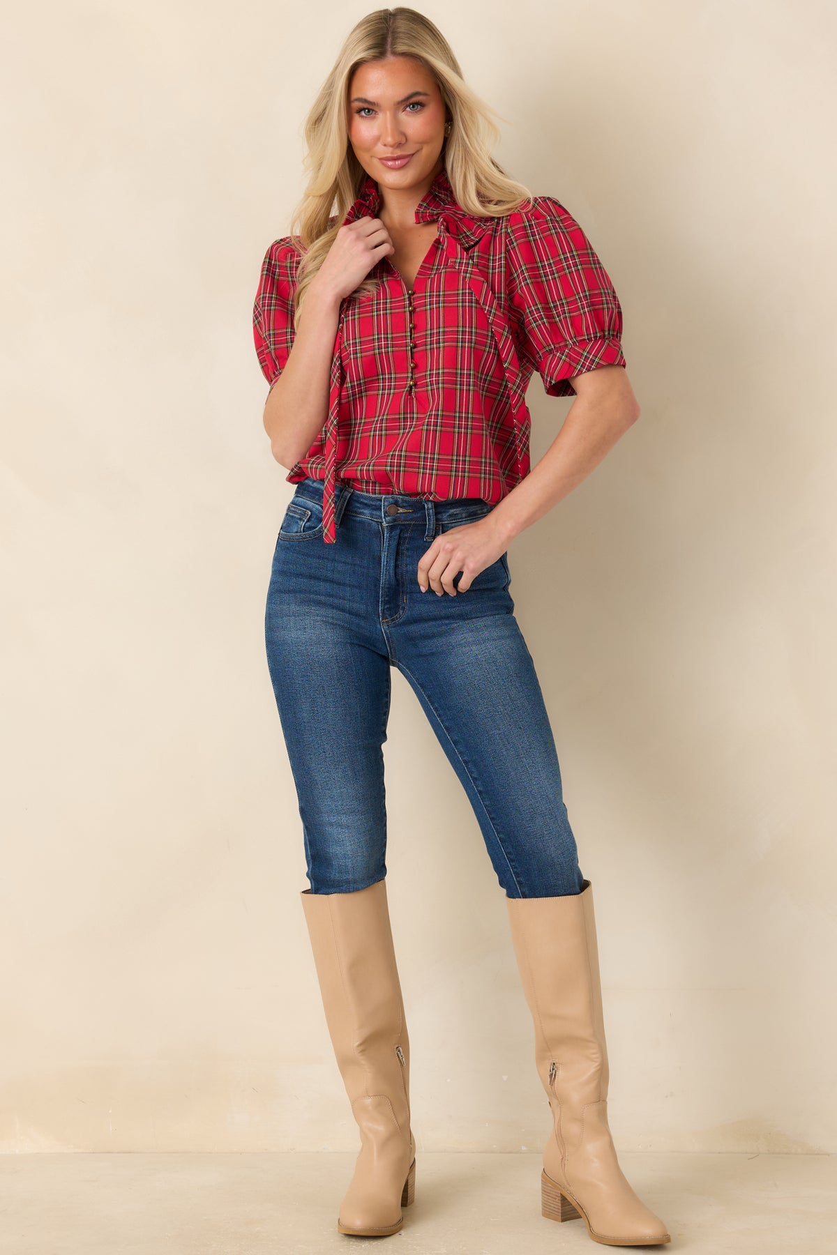 Classic plaid top with a statement neck bow, gathered puff sleeves, and a relaxed silhouette.