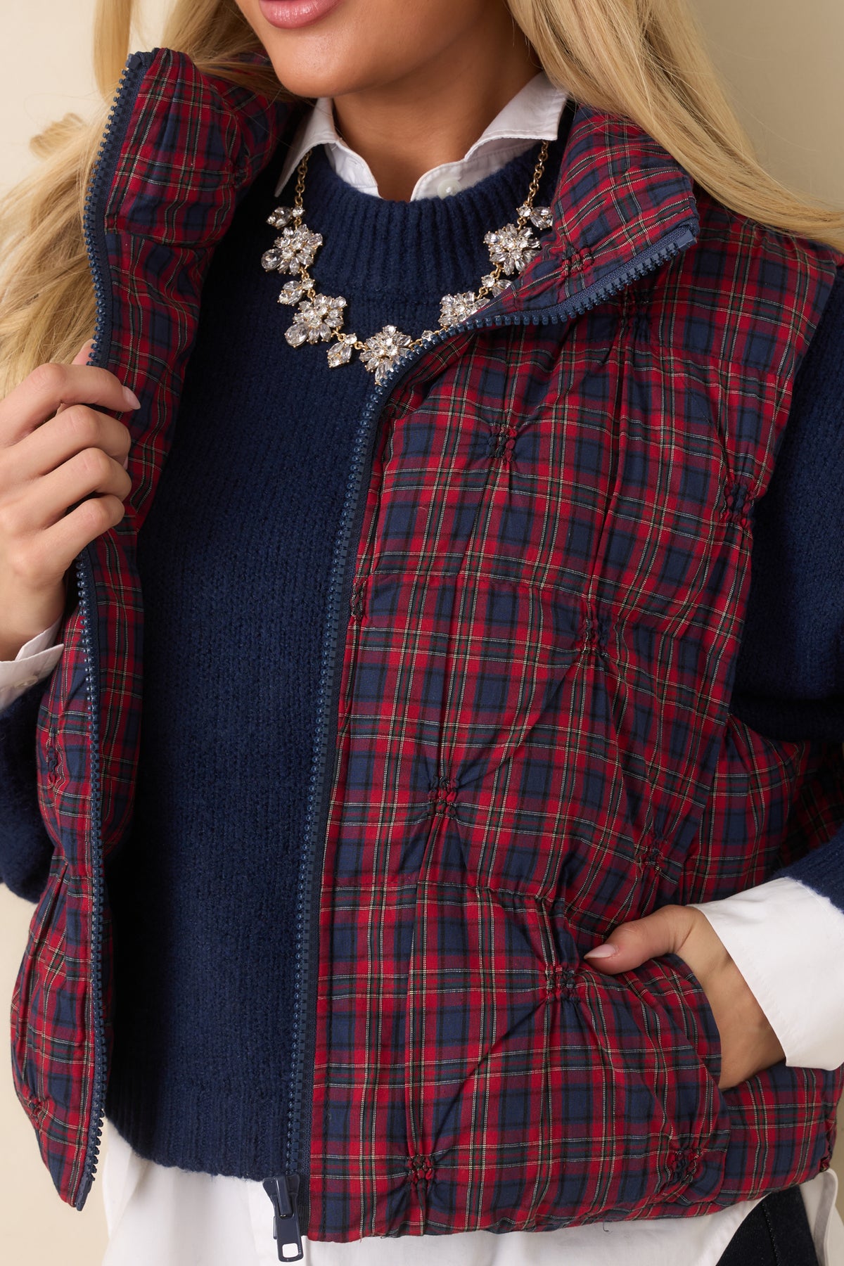 Close-up of the vest’s rounded quilting and plaid cotton fabric.