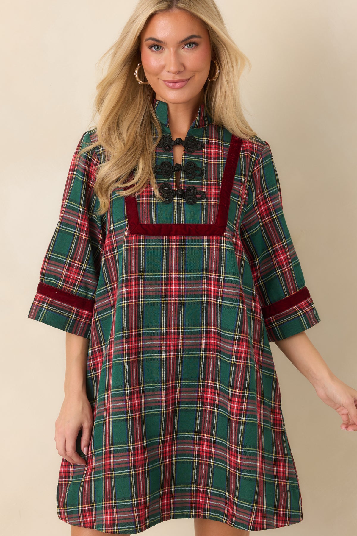 Three-quarter plaid sleeves finished with burgundy velvet trim at the cuffs.