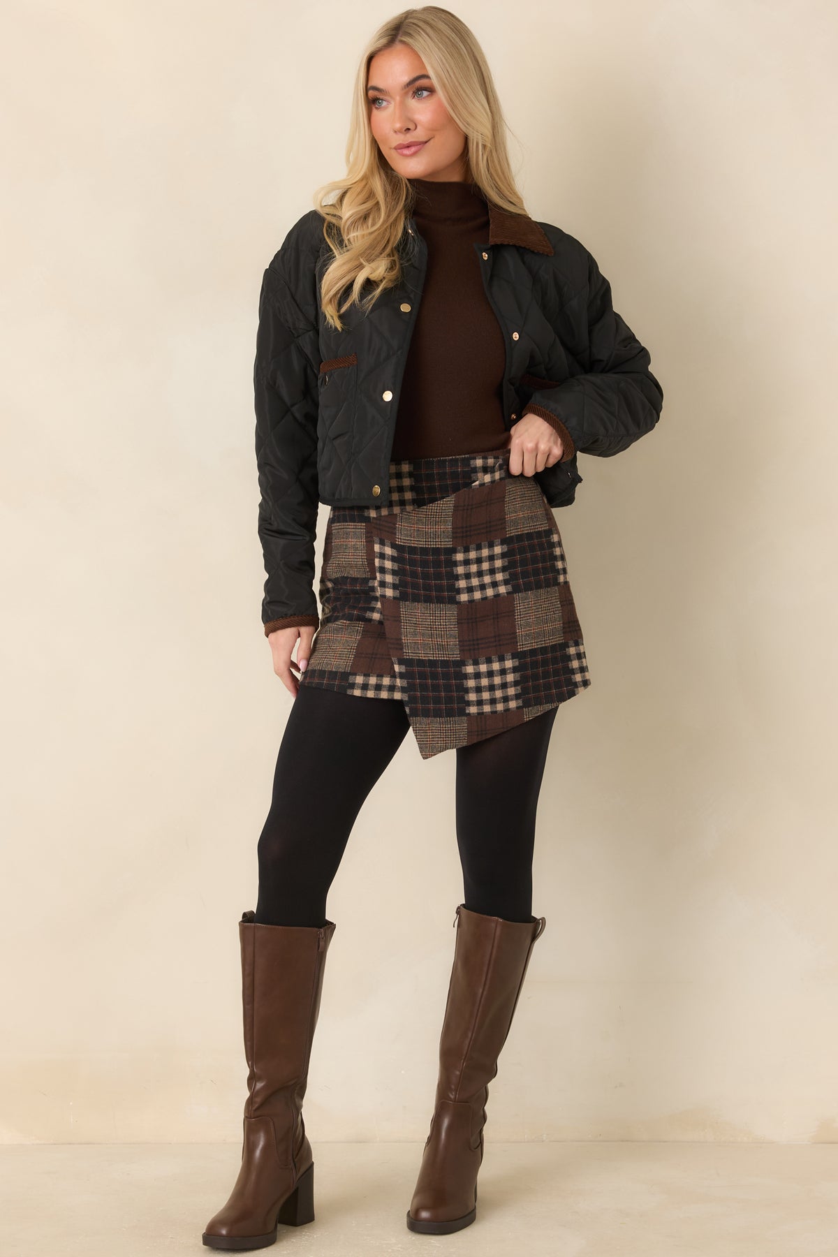 Plaid and gingham skirt featuring a smooth waistband and gently flared silhouette with an asymmetric hem.