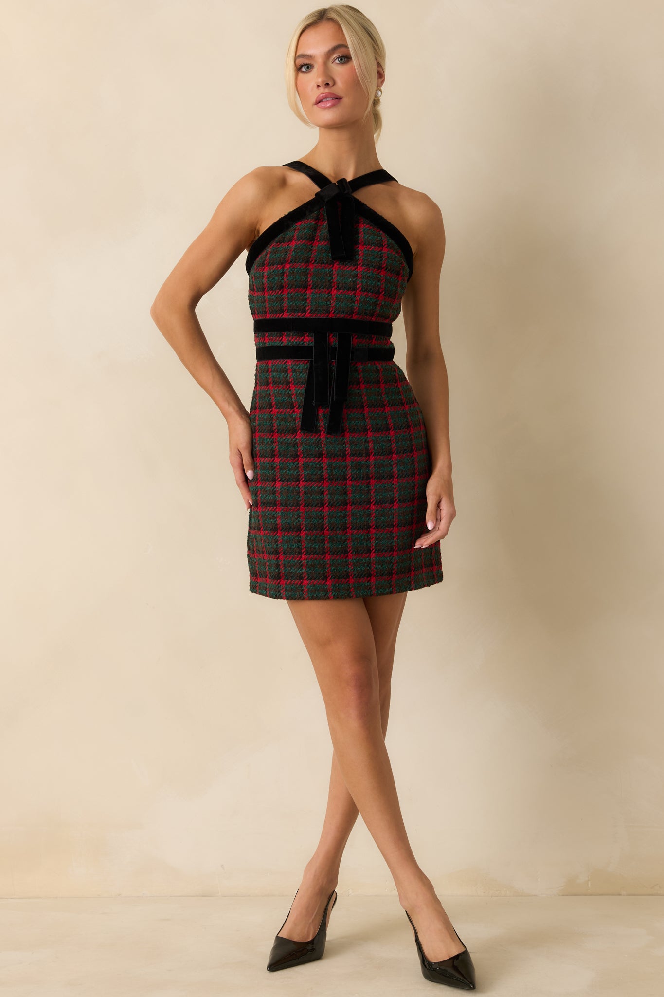 Plaid tweed dress featuring velvet trim and a bow accent paired with a defined velvet waist panel.