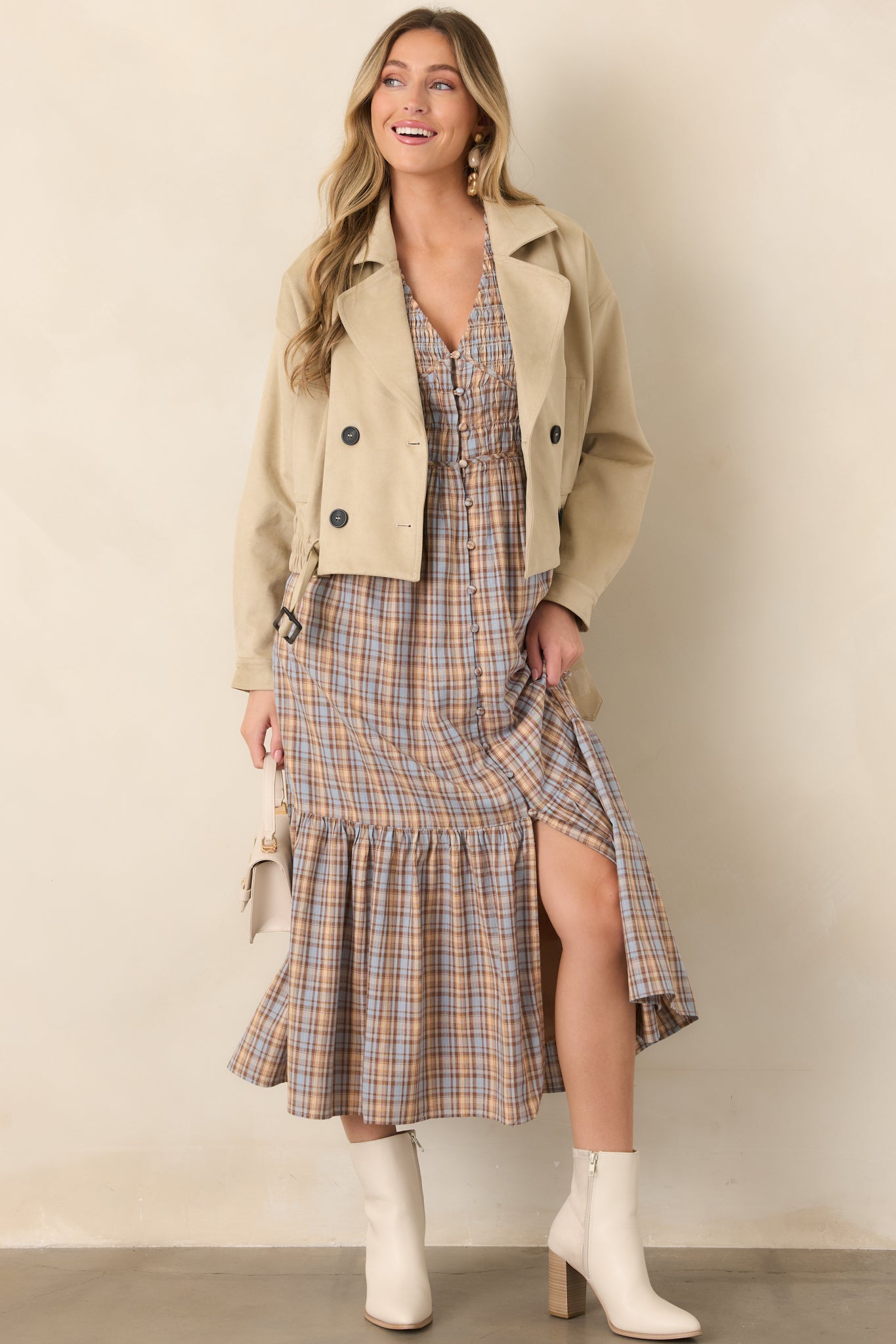 Plaid midi dress with a flattering V-neck bodice, fabric-covered buttons, defined waist, and gathered tier along the skirt hem.
