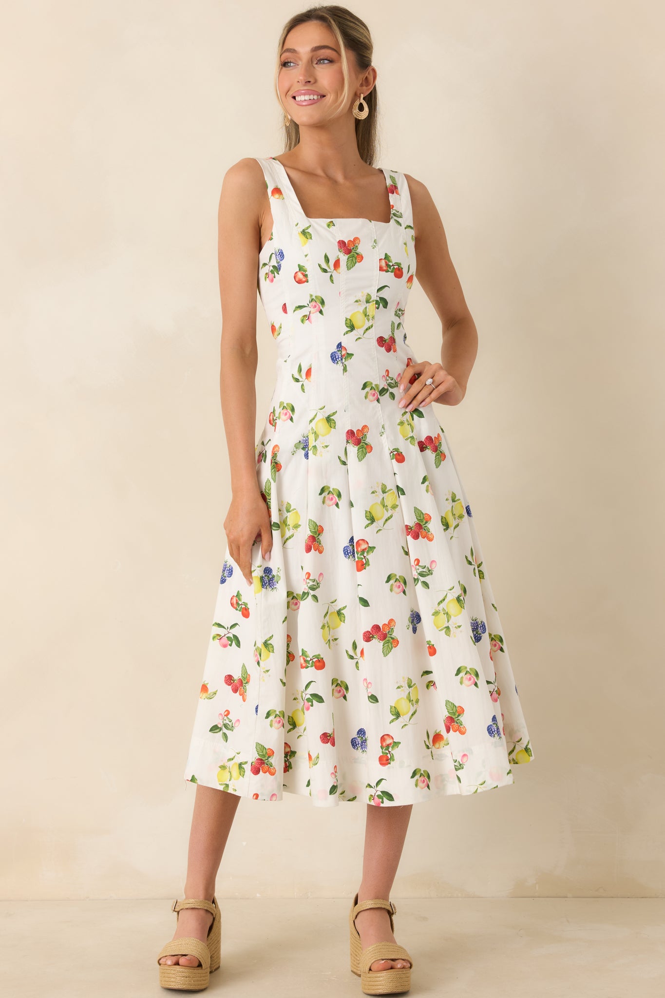 Playful fruit-printed midi dress featuring vertical seam detailing and breezy pleated waist