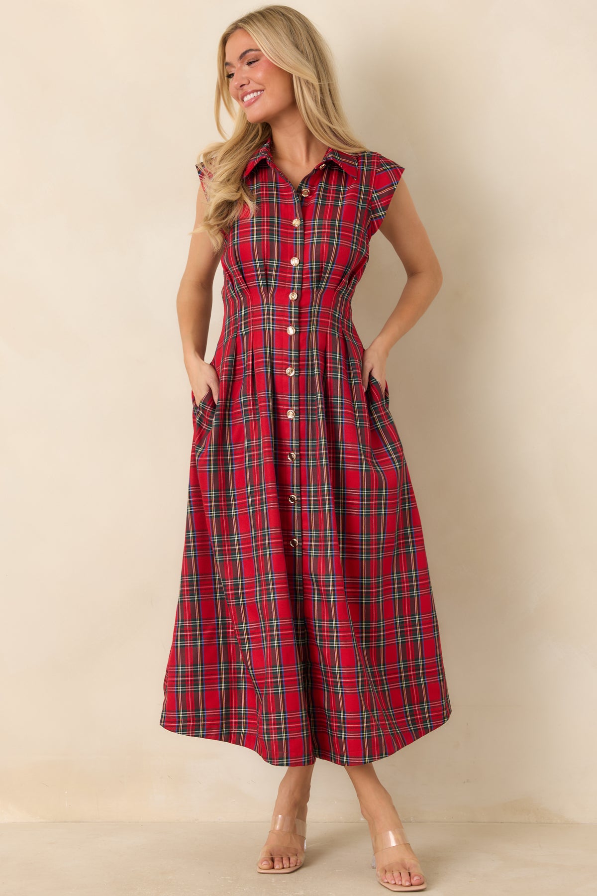 Pleated midi dress with gleaming gold-tone buttons, tailored waist seams, and short structured cap sleeves.