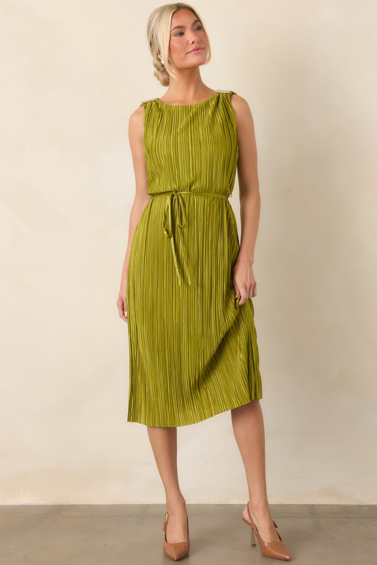 Elegant pleated midi dress showcasing its softly flowing silhouette, subtle metallic sheen, gold shoulder accents, and defined waistline.