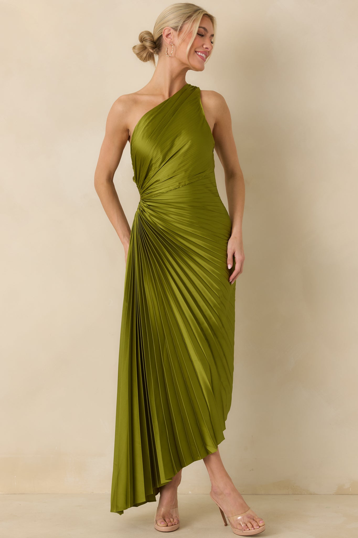Pleated olive maxi dress featuring a fitted bodice and subtle side cutout detail.