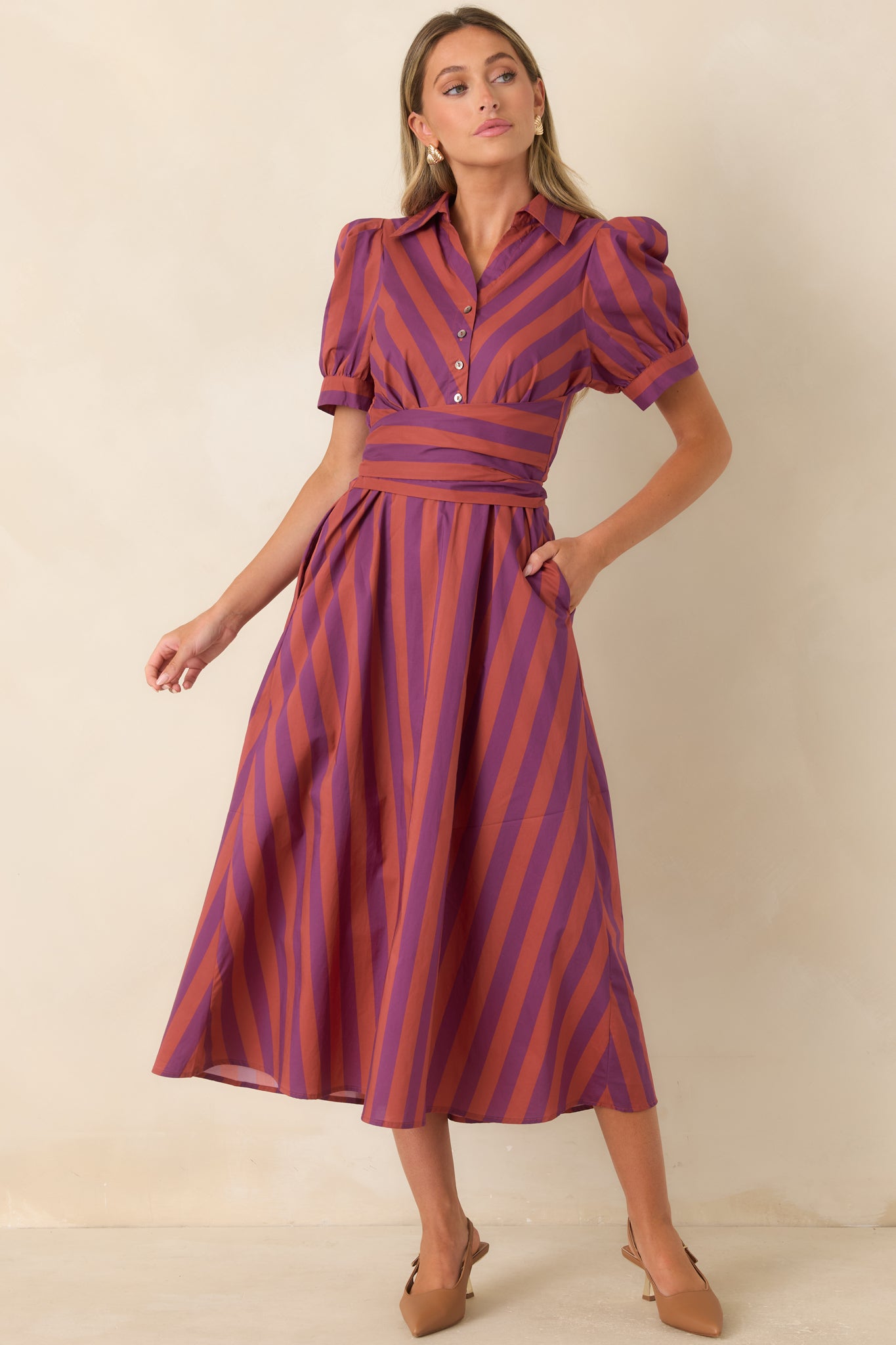 Plum and burgundy striped midi dress featuring a collared neckline, functional button-front closure, and softly puffed short sleeves.