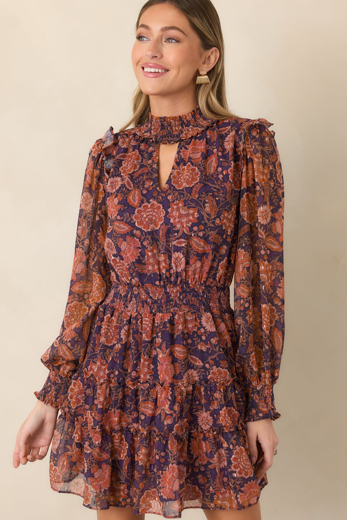 Close view of the wide smocked waist defining the deep plum floral dress silhouette.