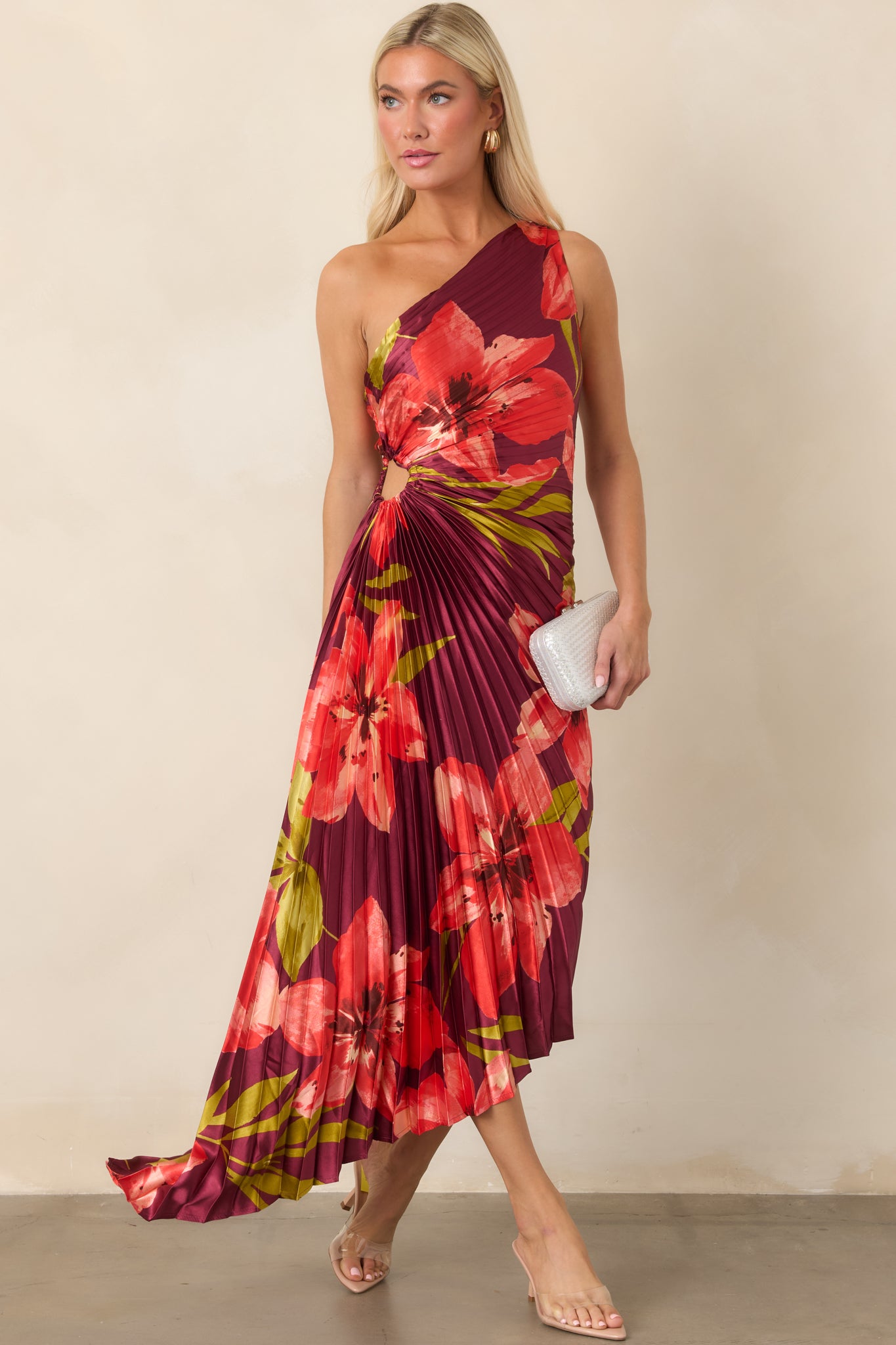 One-shoulder plum satin dress designed with colorful floral print, ruched waist detailing, and a sculptural asymmetrical silhouette.