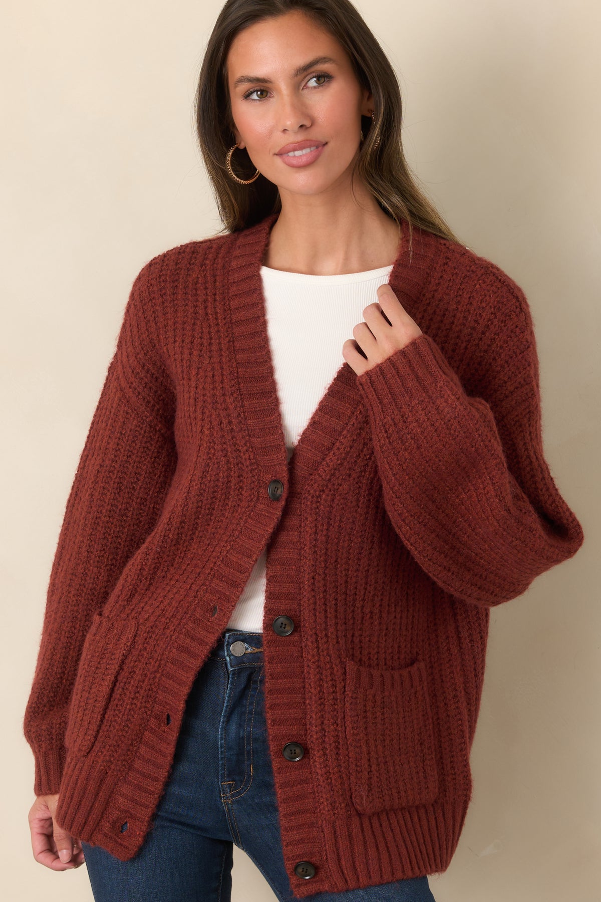 Plush cardigan highlighting the long sleeves, dropped shoulders, and straight ribbed hem at the hip.