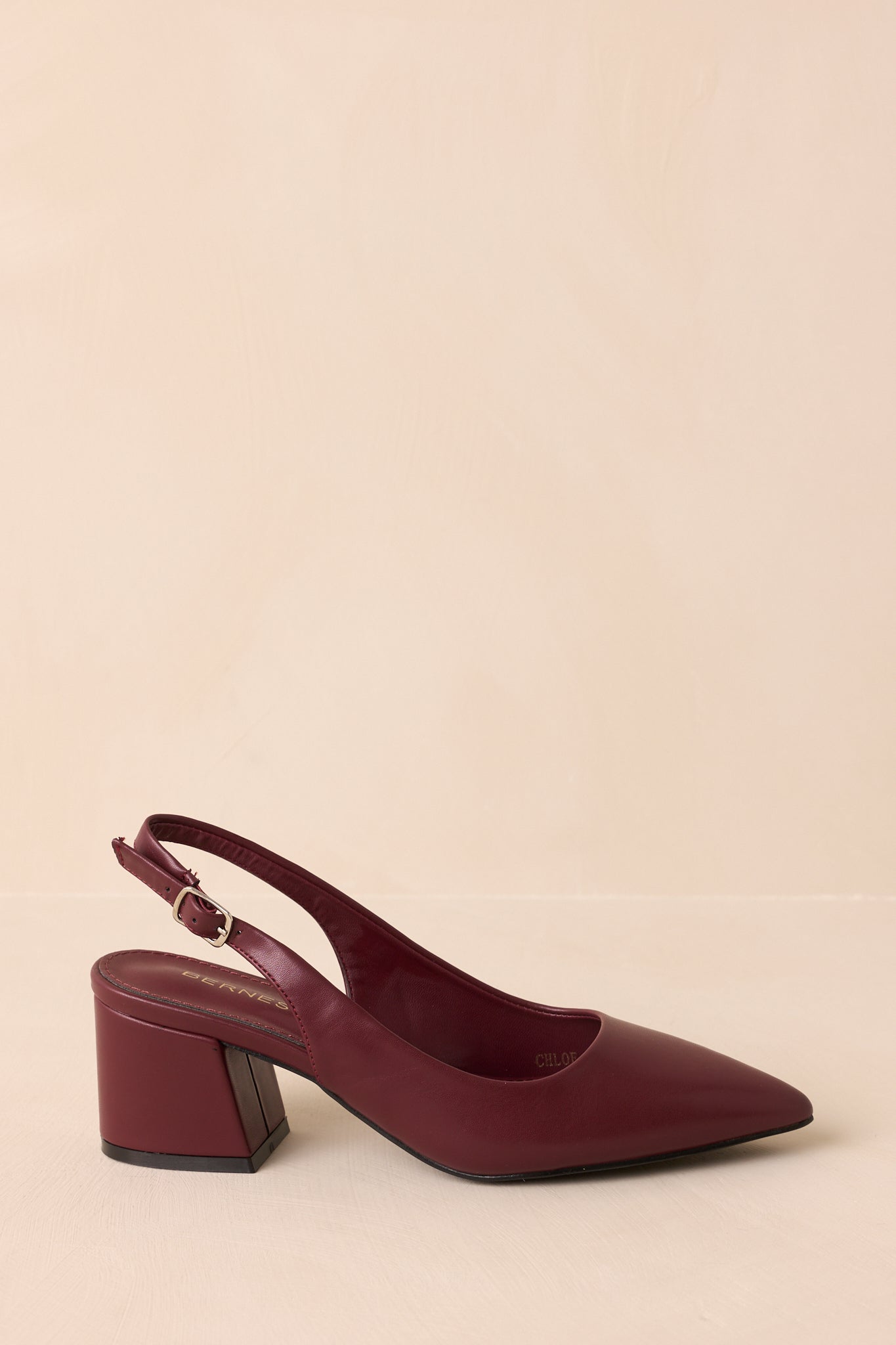 Side view of pointed-toe heels featuring adjustable slingback strap.