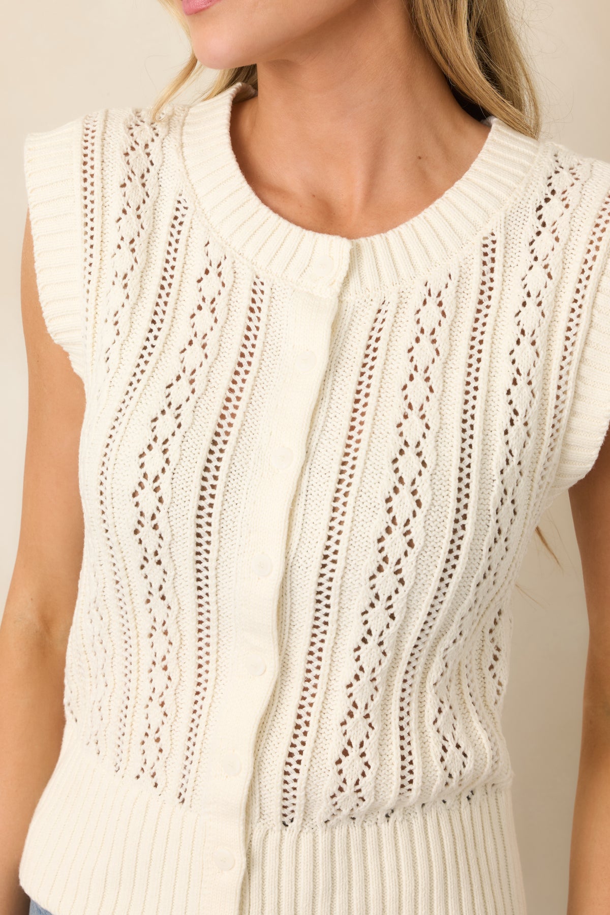 Pointelle and cable knit textures with wide ribbed neckline trim.