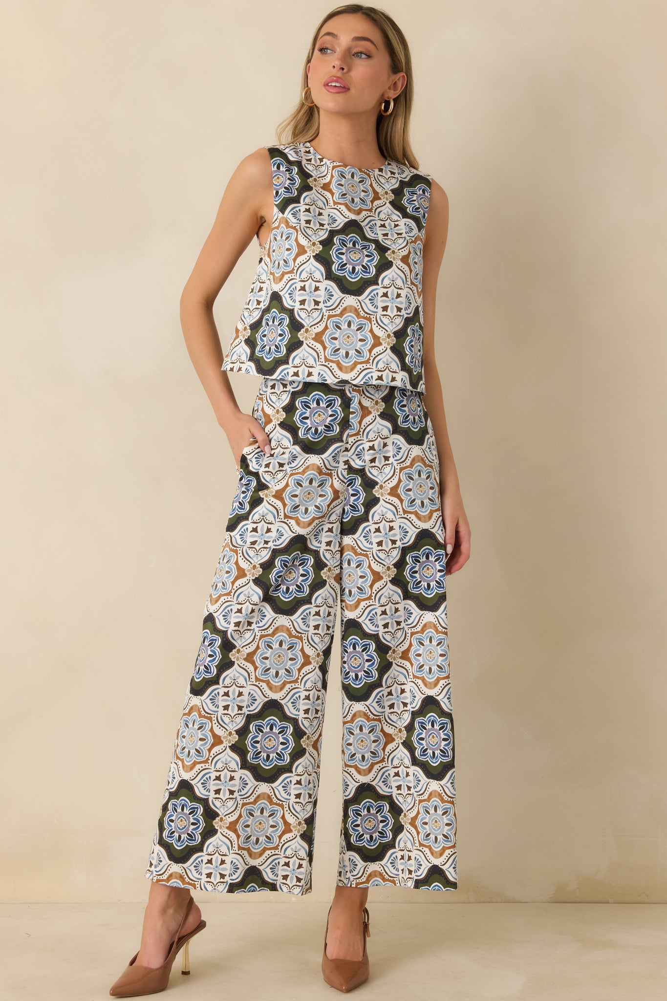 Polished sleeveless top featuring colorful medallion motifs, a round neckline, and a clean slightly cropped shape.