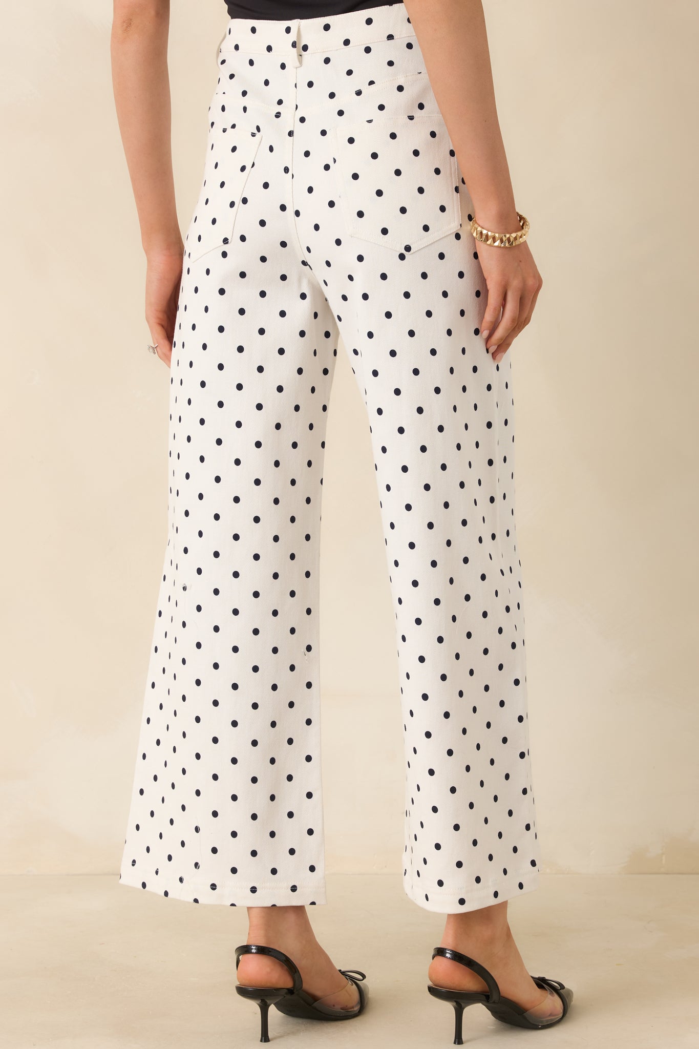 Polka dot straight-leg pants with high-rise waist and clean rear silhouette.