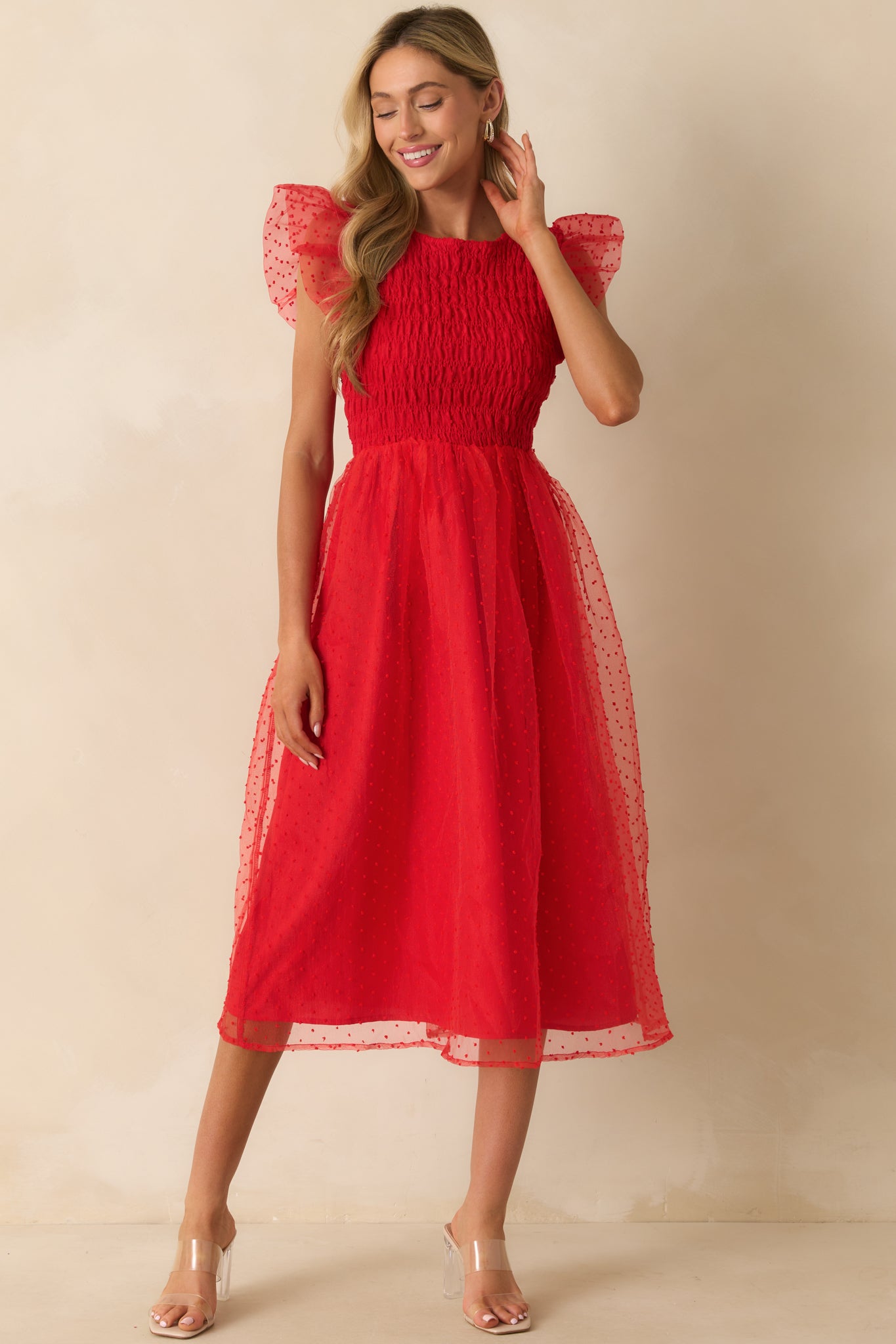 Polka dot tulle dress with smocked bodice and flowy silhouette.