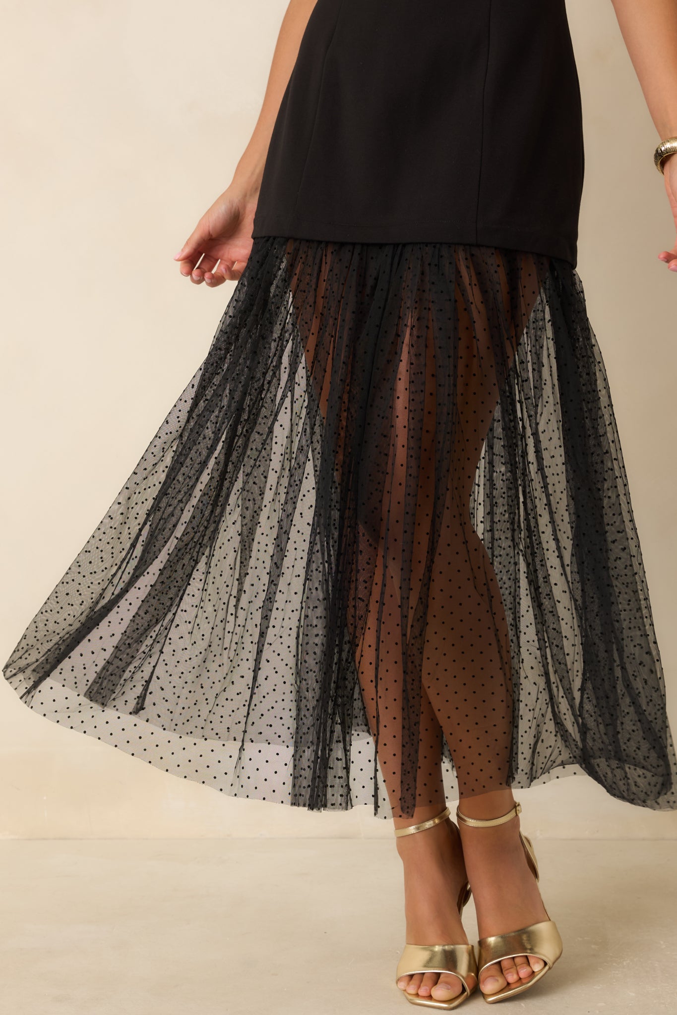 Close-up highlighting the princess seam construction, smooth stretch fabric, round neckline, and sheer Swiss dot mesh hem detailing.