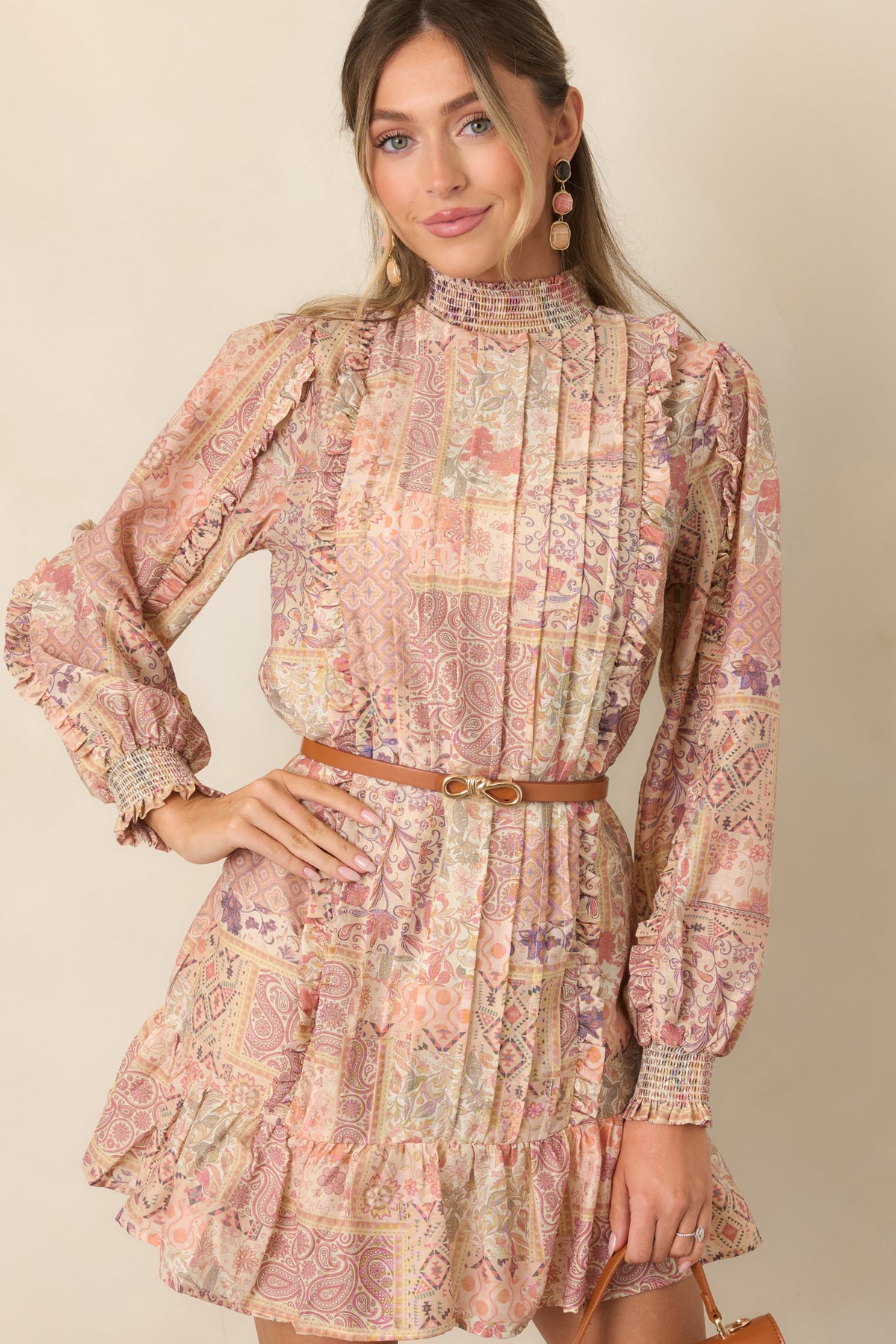 Long balloon sleeves finished with coordinating smocked cuffs on the printed mini dress.