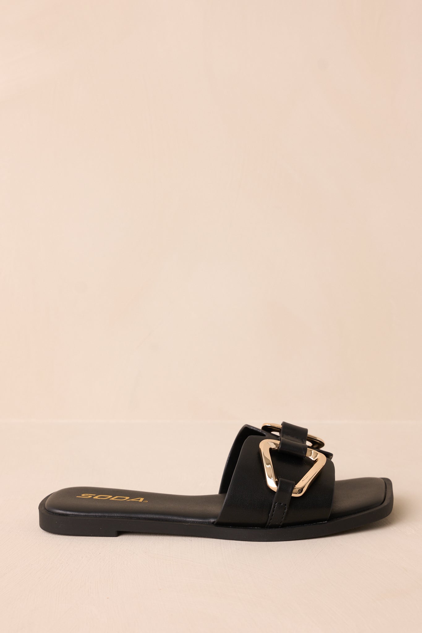 Profile shot of the sandal displaying the shape, notched band, and sleek design of the slip-on style.