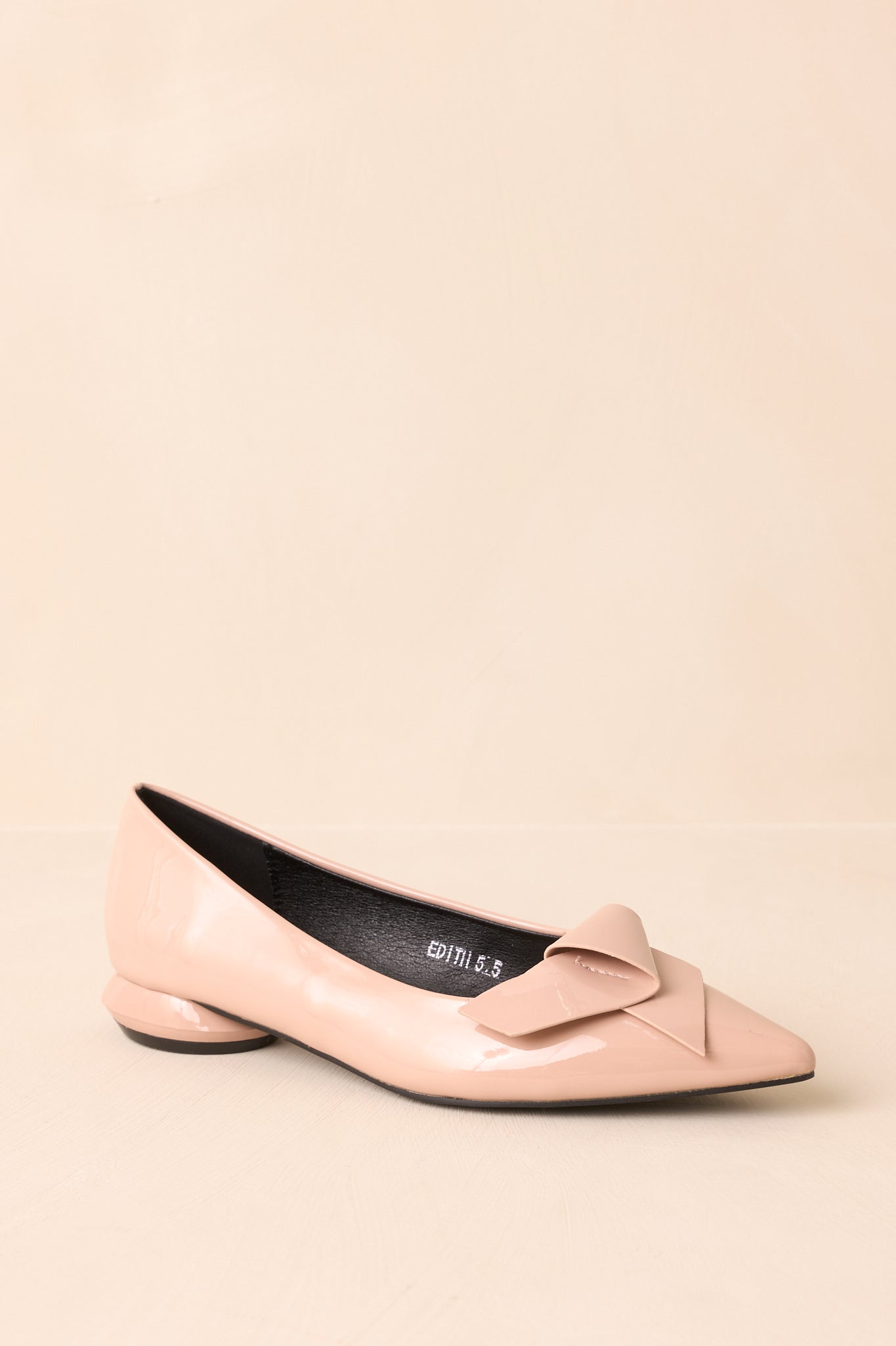 Profile view of the flats, focusing on the cushioned insole and patent faux leather material.