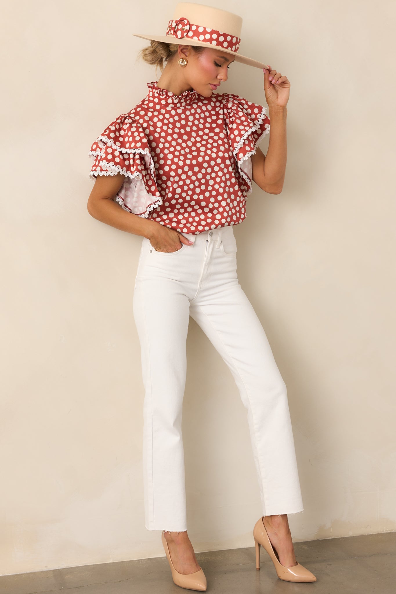 Brick red top with white polka dots, ruffle mock neckline, and short ruffle sleeves with ivory eyelet trim.