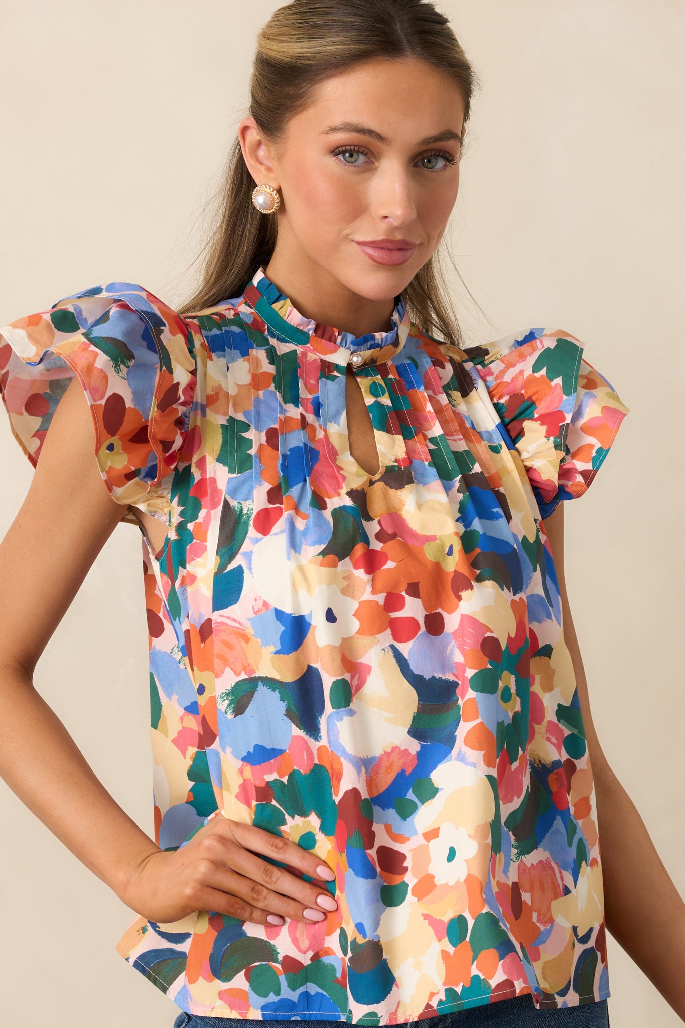 Cropped look highlighting the short flutter sleeves and floral print pattern.