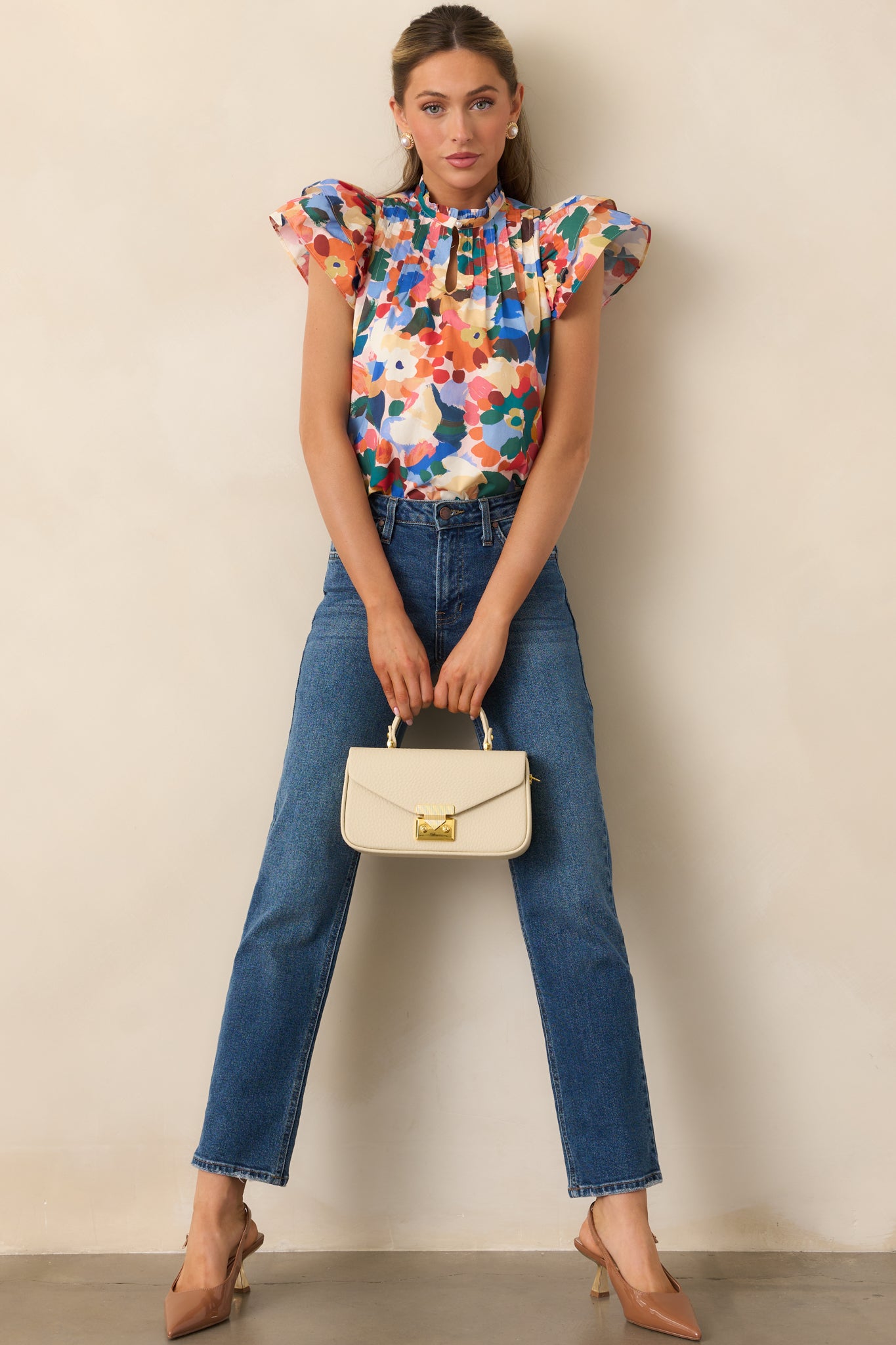 Floral top with playful ruffle neckline, pintuck details, and comfortable, relaxed shape.