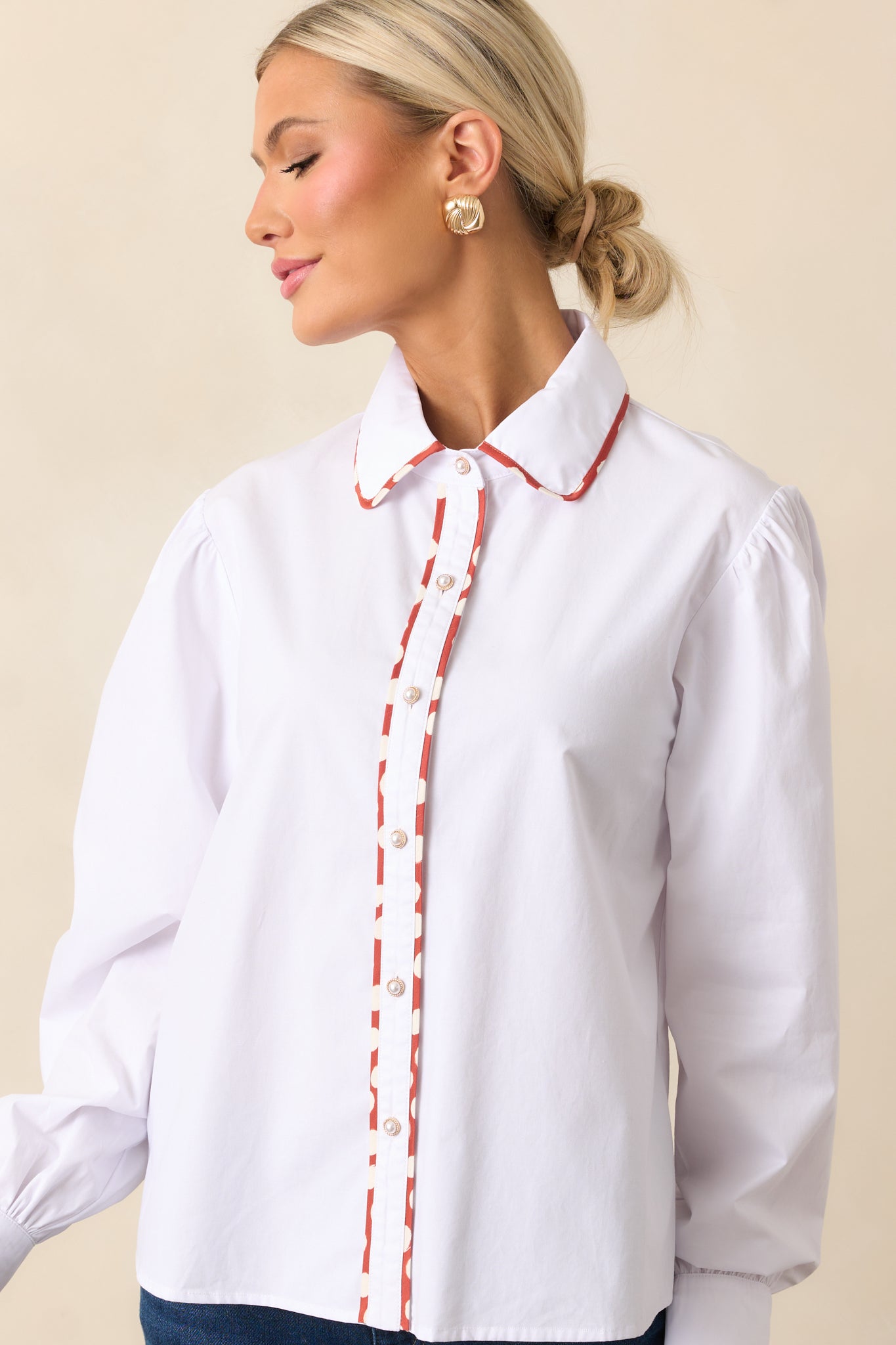 Close-up view highlighting the collared neckline and polka dot contrast trim.