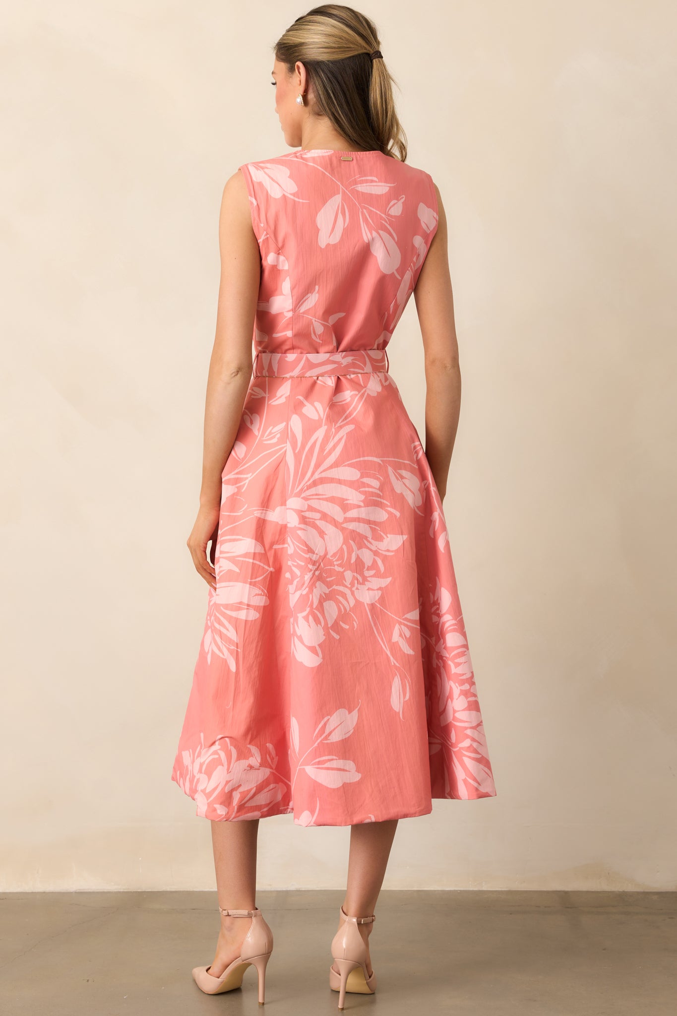 Rear view of the midi dress showing rose floral panel and relaxed silhouette.
