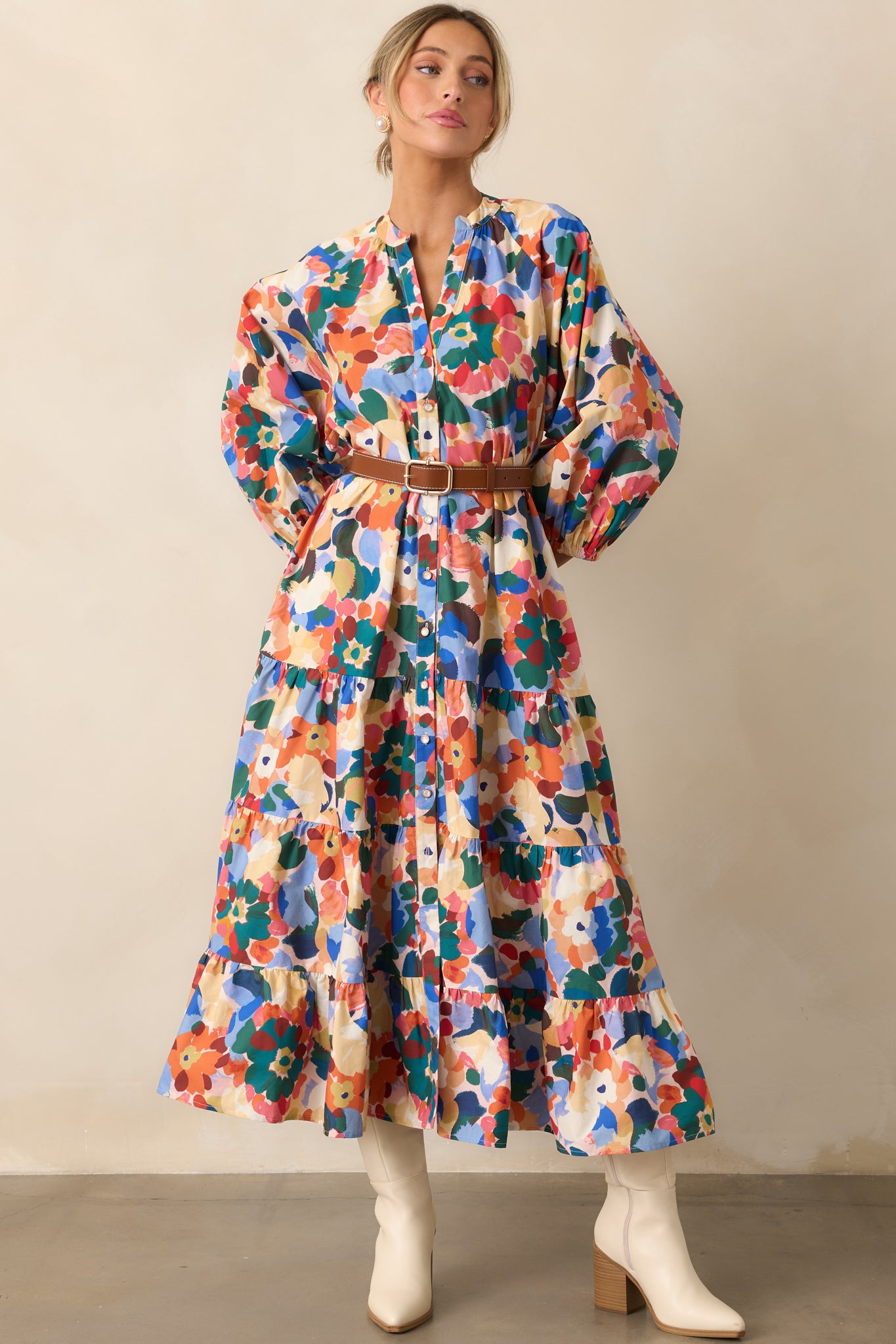 Maxi dress in a vibrant orange multicolor floral print with a notch v-neckline and functional button front.