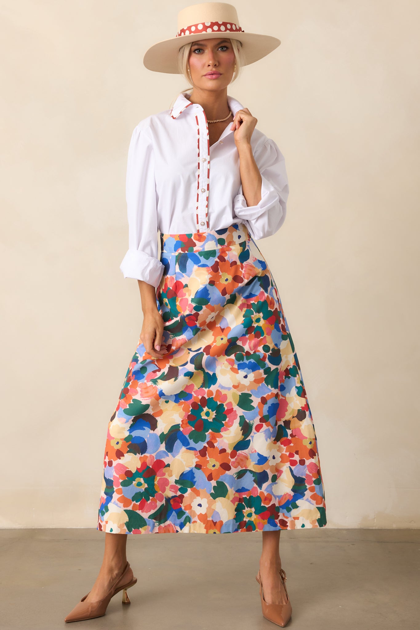 High-rise midi skirt in orange floral print with an elegant, relaxed fit.