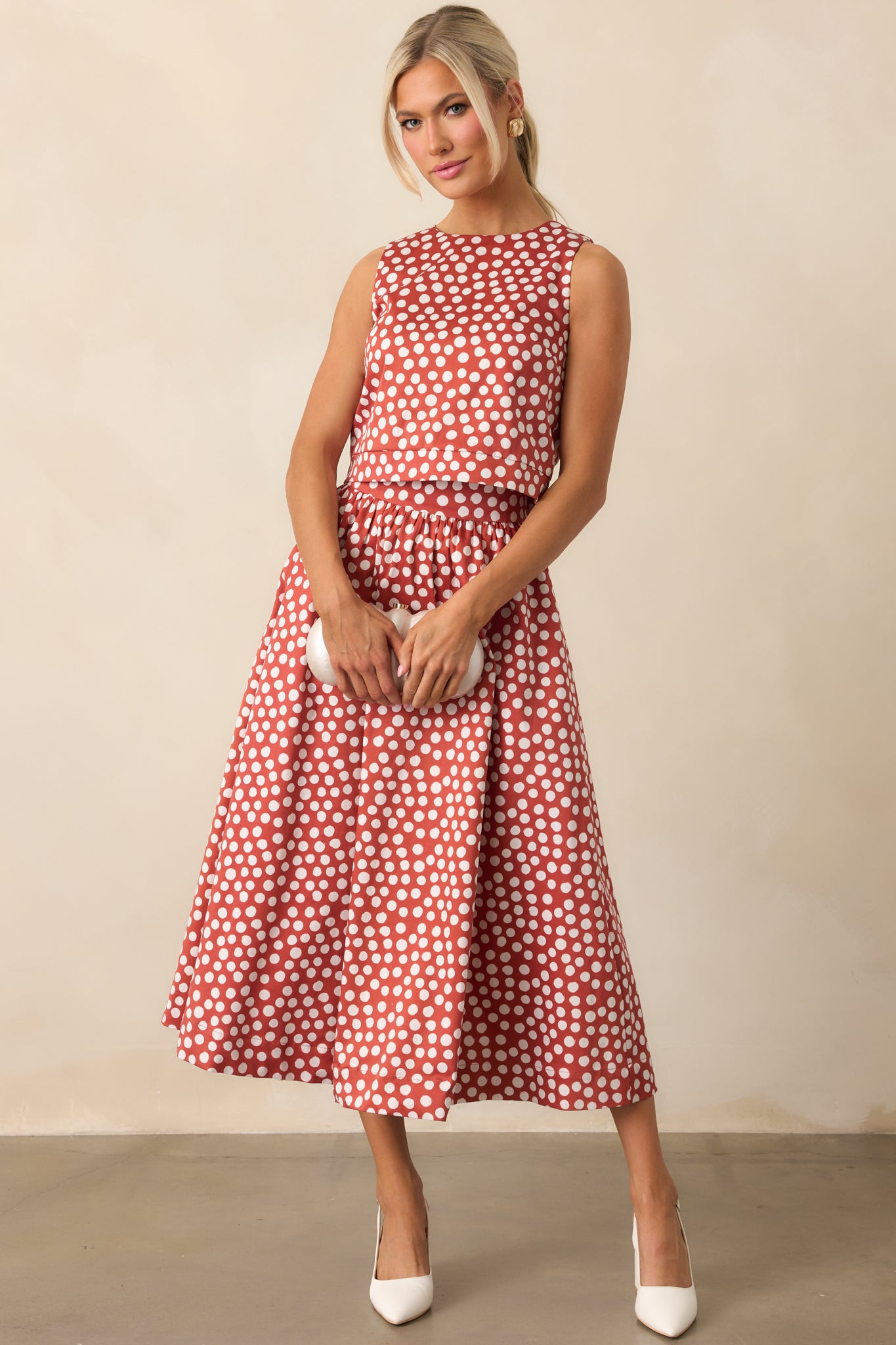 Cropped polka dot top featuring a fitted shape and classic crew neckline.