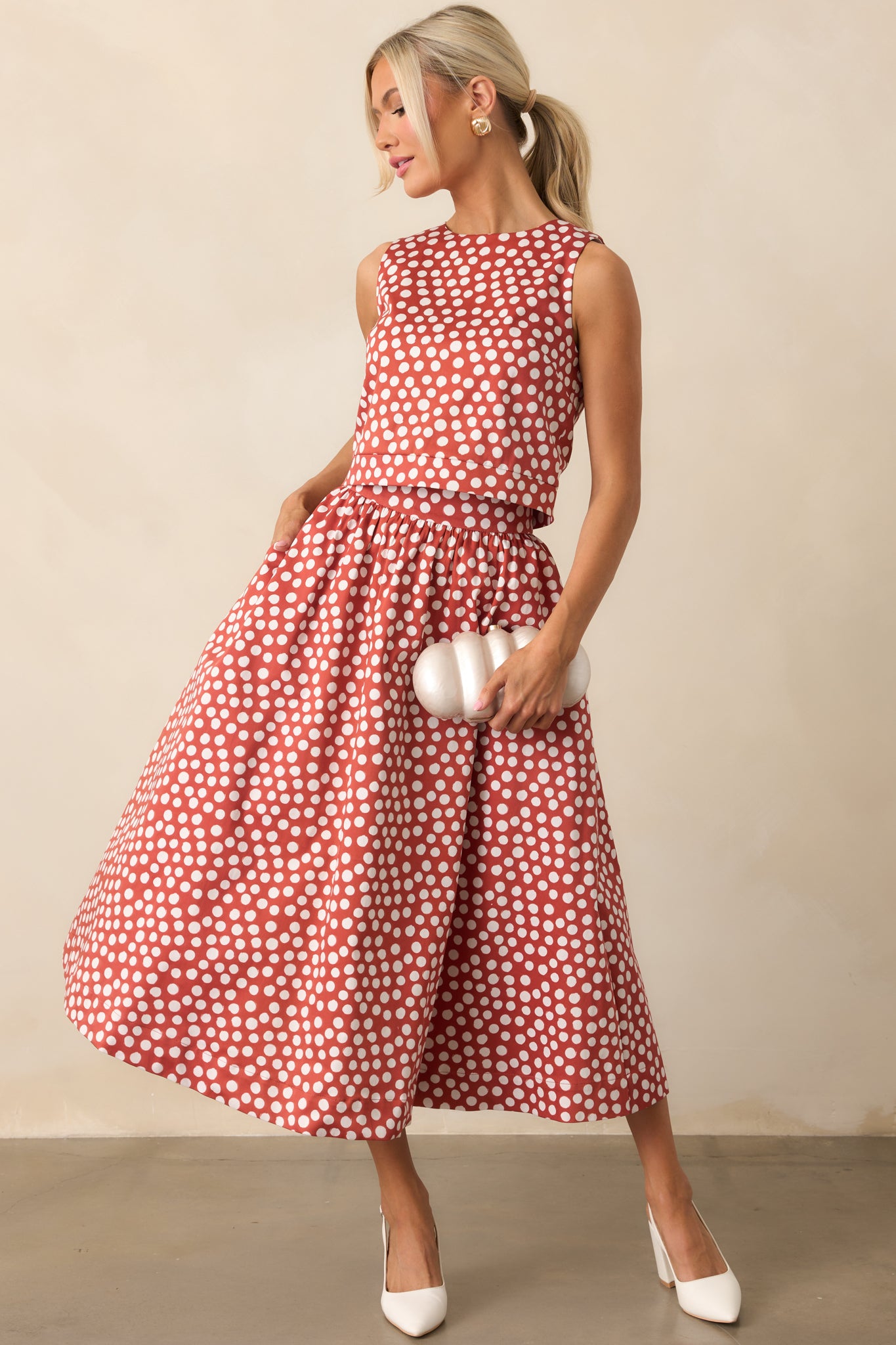 Brick red midi skirt with white polka dots and a flattering high-rise waist.