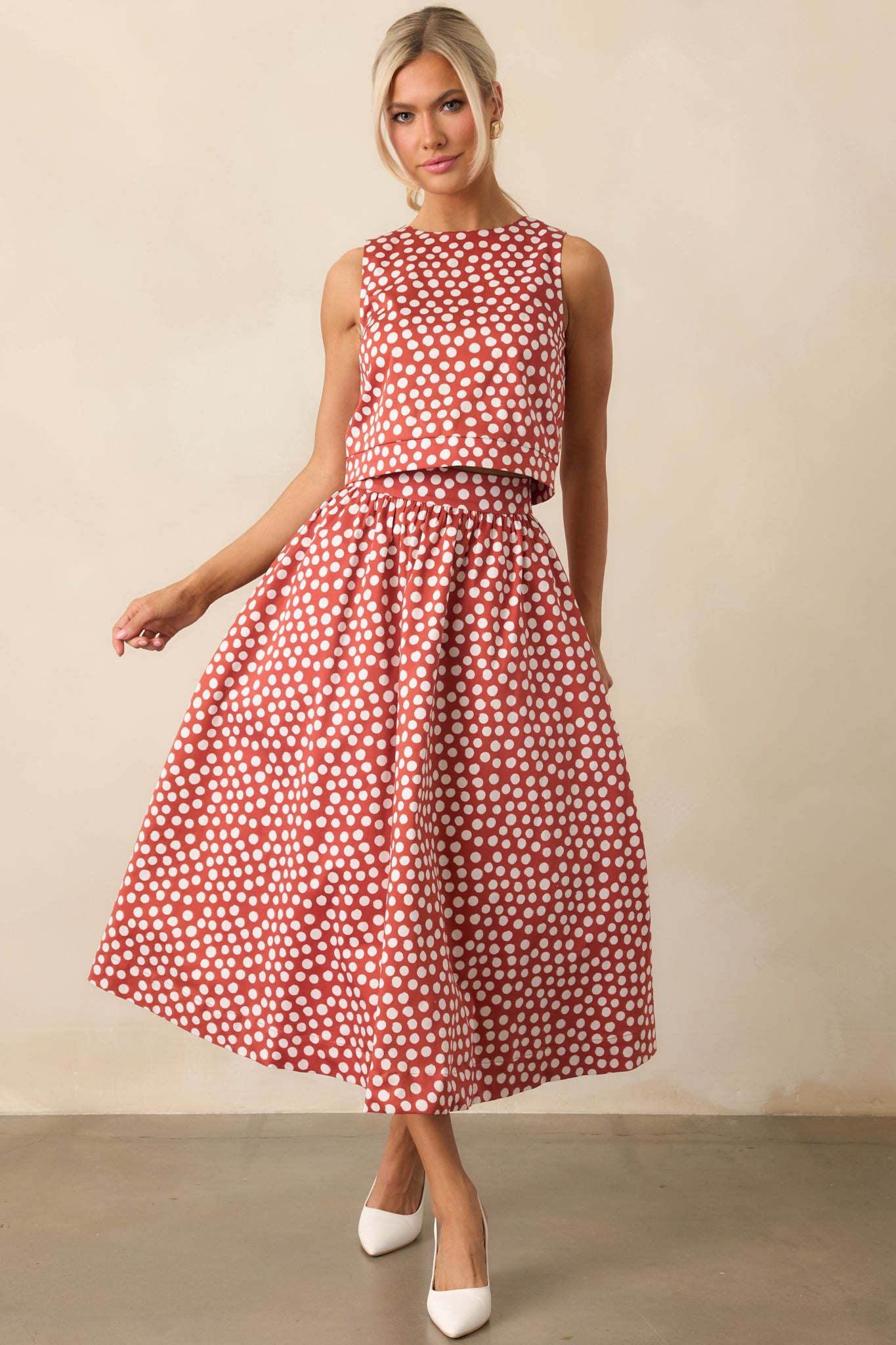 High-rise midi skirt in brick red with playful white dots and a lined finish.