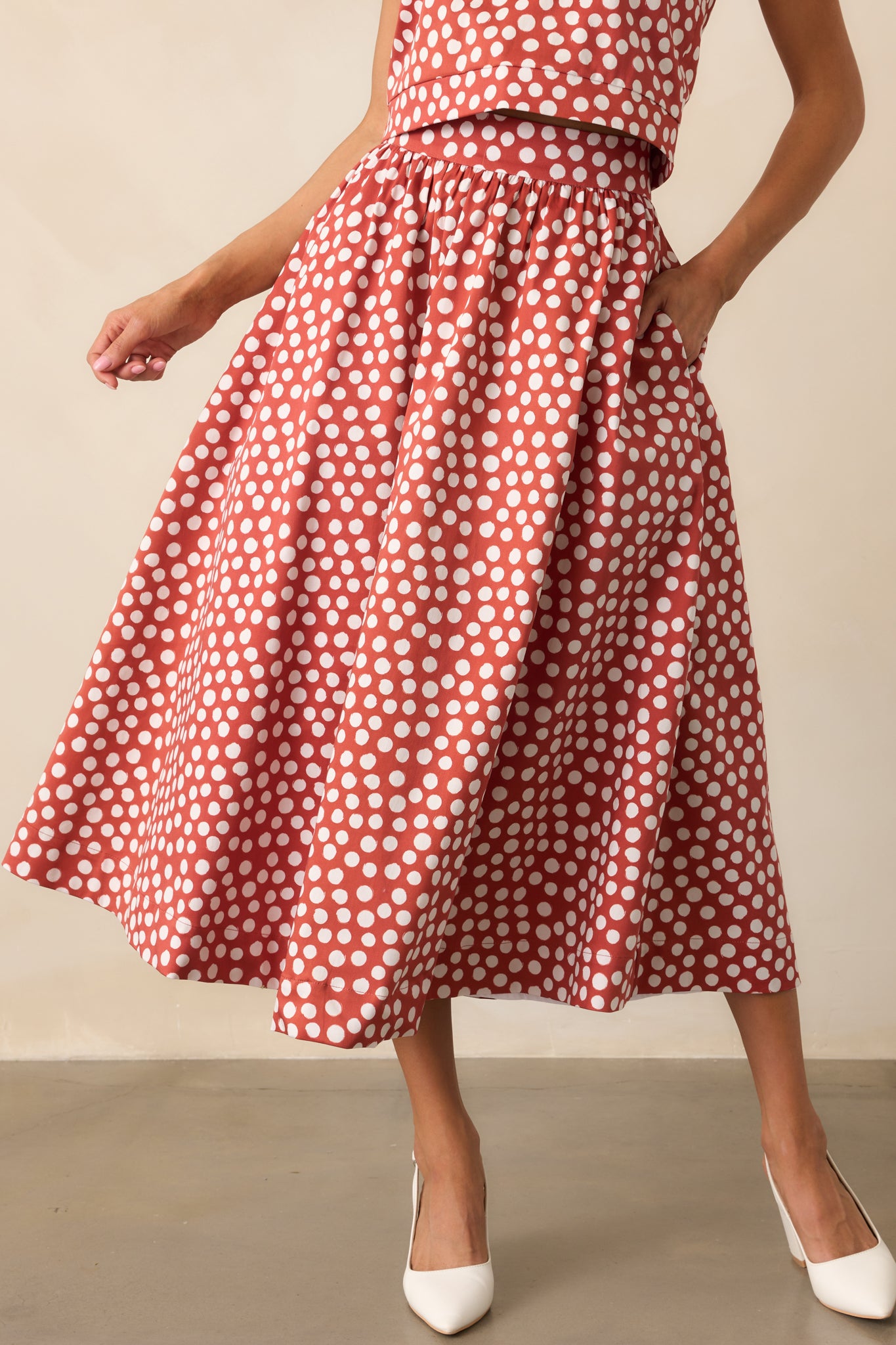 Closer view of the polka dot skirt highlighting the high-rise waistband and pockets.
