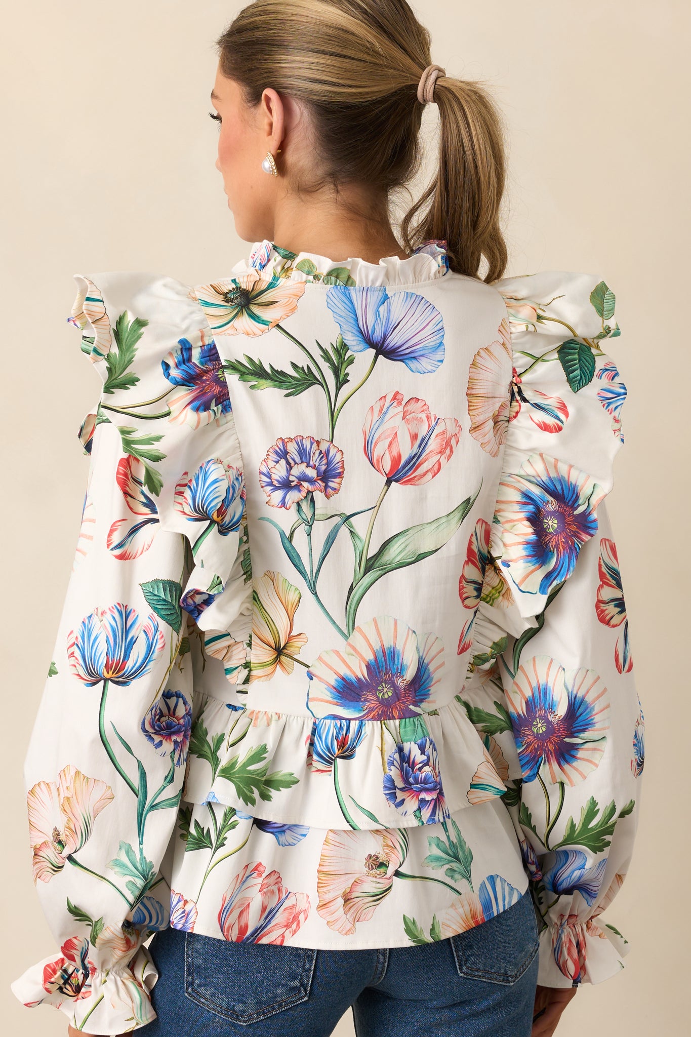 Rear view of the top showing long sleeves with elastic cuffs and relaxed fit.