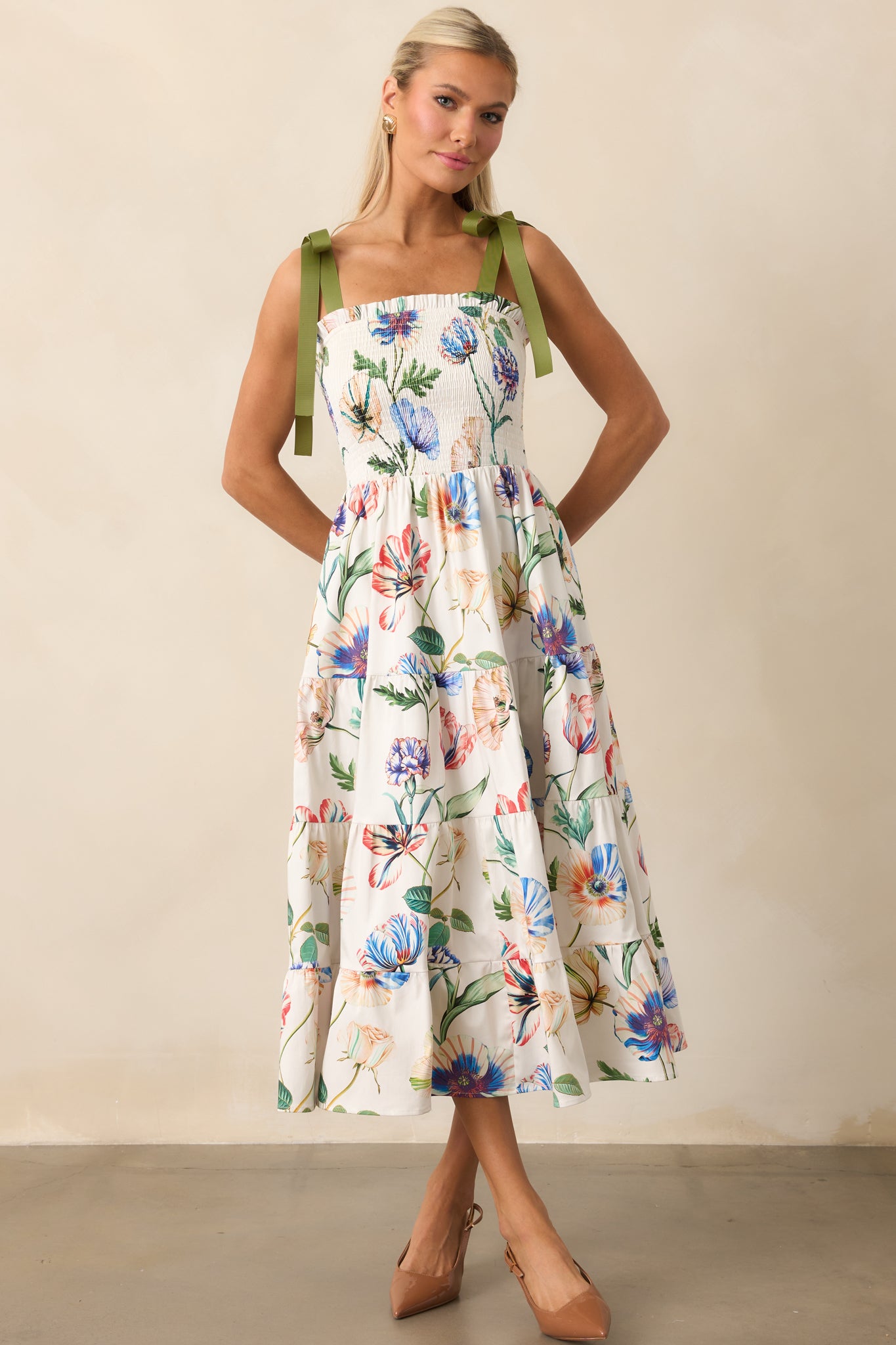 Prosperina floral midi dress featuring a fully smocked bodice and flowing tiered skirt.