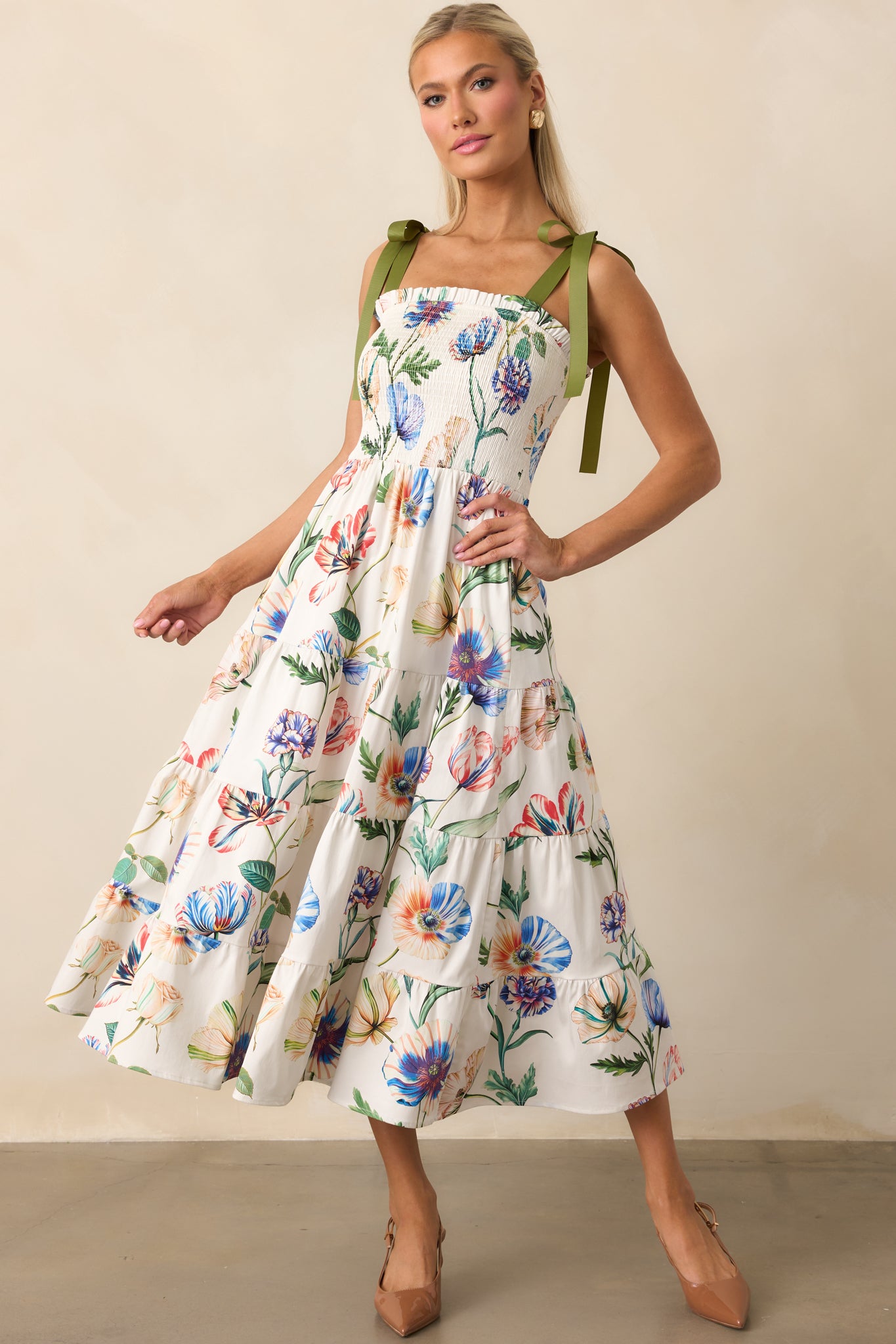 Midi dress with tiered skirt, functional side pockets, and relaxed, feminine silhouette.