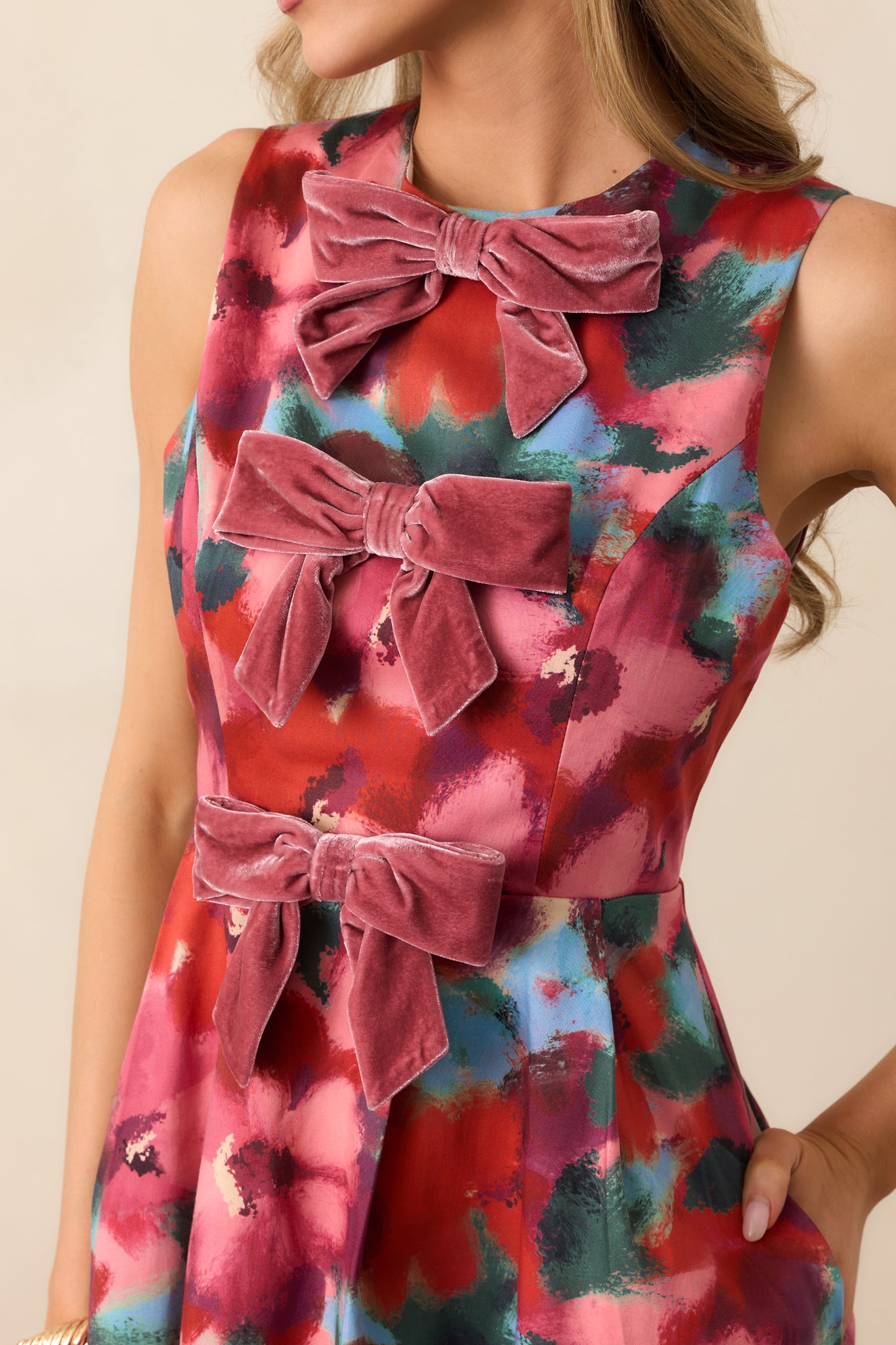 Close-up of the velvet bows and abstract floral print showing the rich color contrast and fabric detail.
