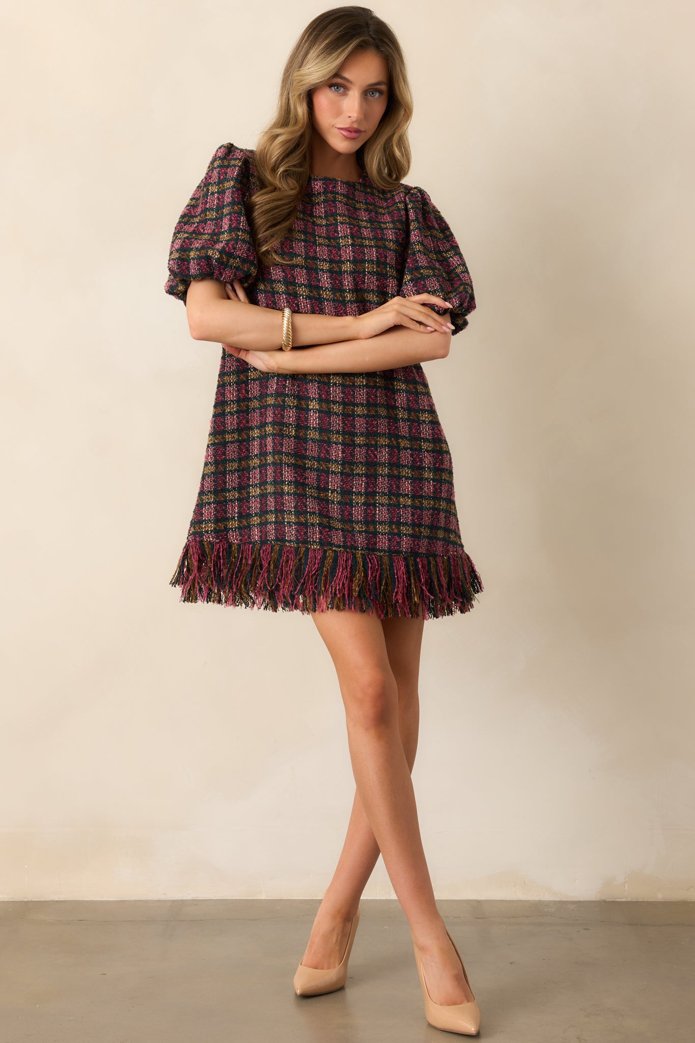 Multicolor tweed shift dress showing its round neckline and easy, structured shape.