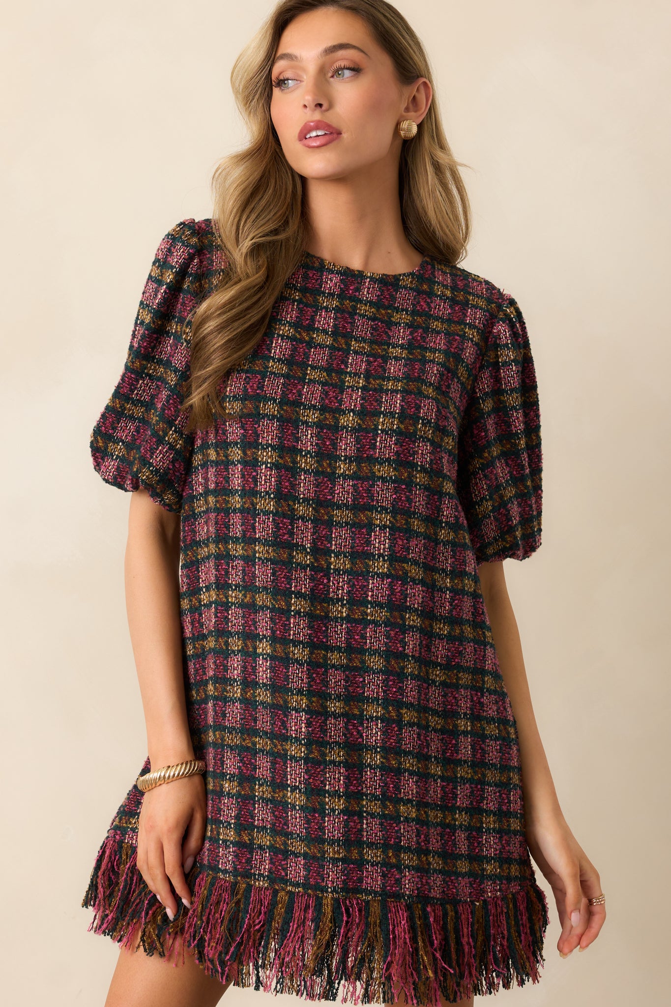 Detailed look at the puff sleeve design and round neckline of the plaid tweed dress.