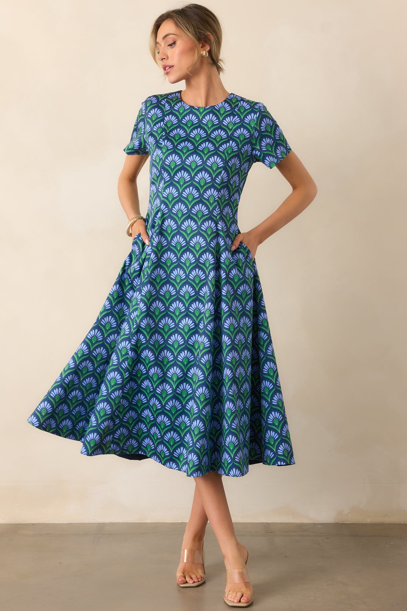 Dress showing short sleeves and asymmetrical design with vibrant geometric print panel