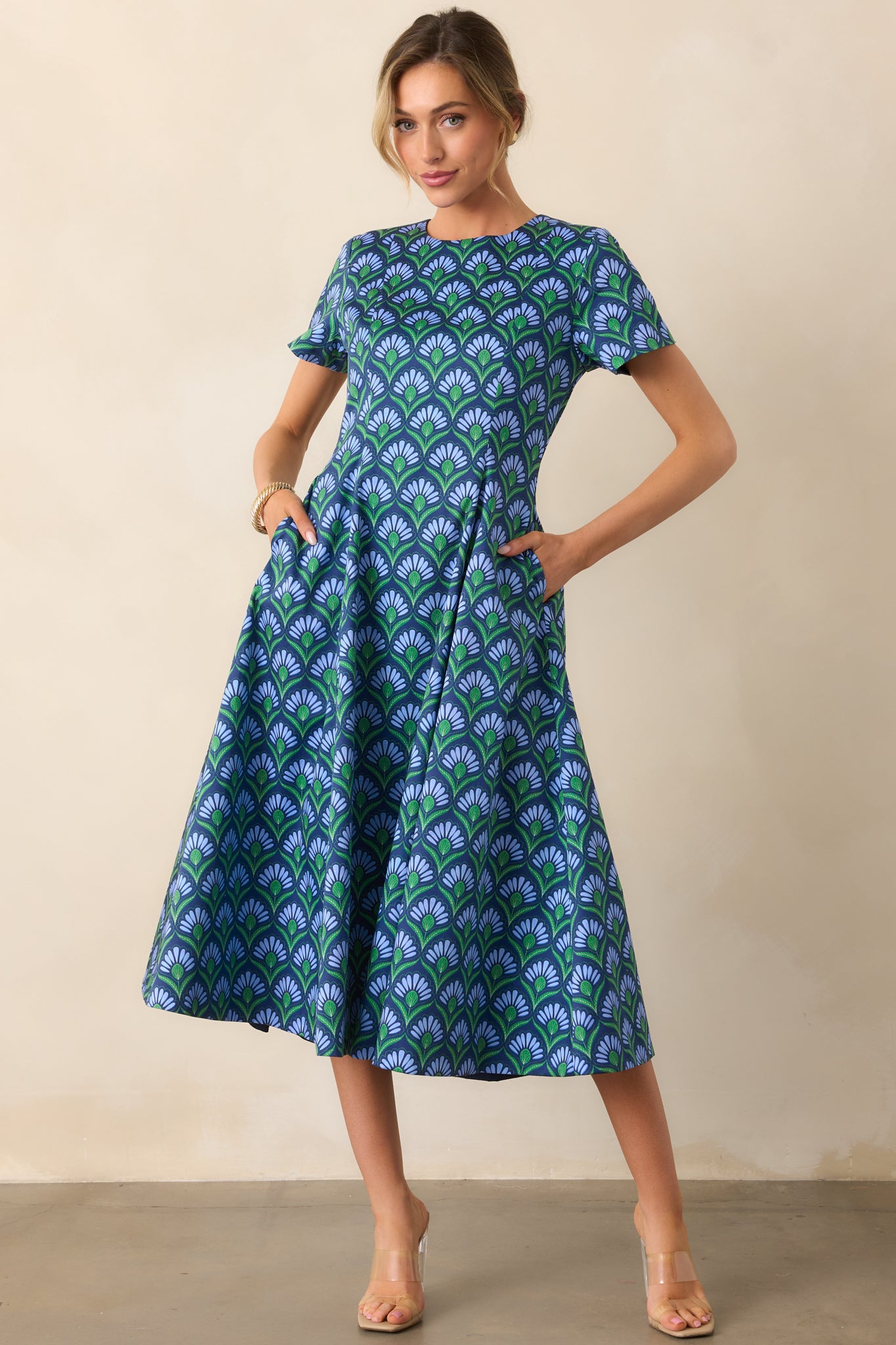 Geometric print side of the dress emphasizing the crew neckline and smooth fabric drape.
