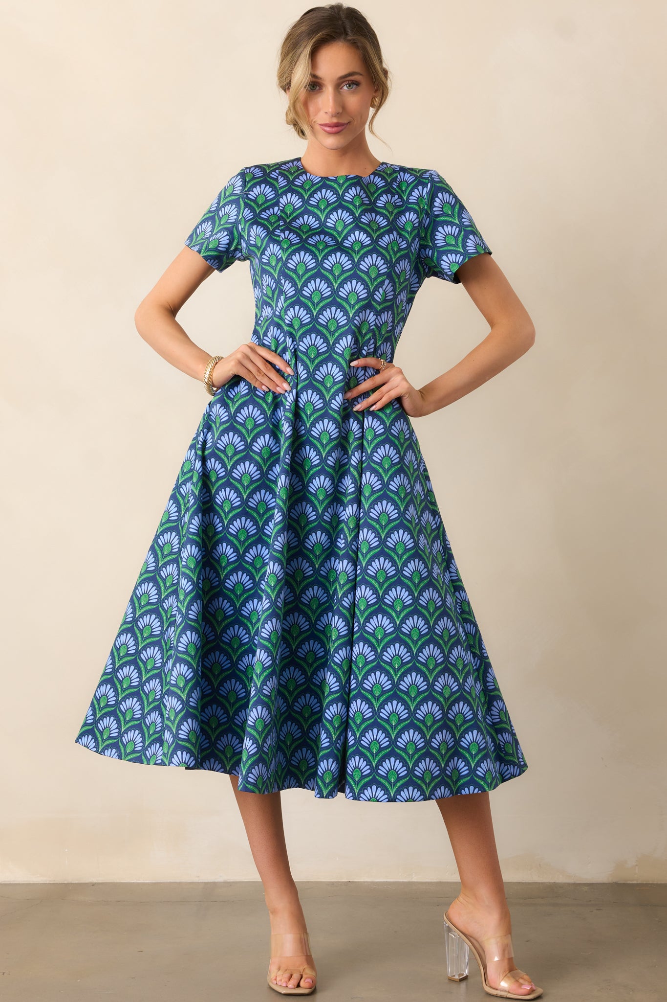 Fitted midi dress showing the geometric print side and subtle contrast with solid midnight blue panel.