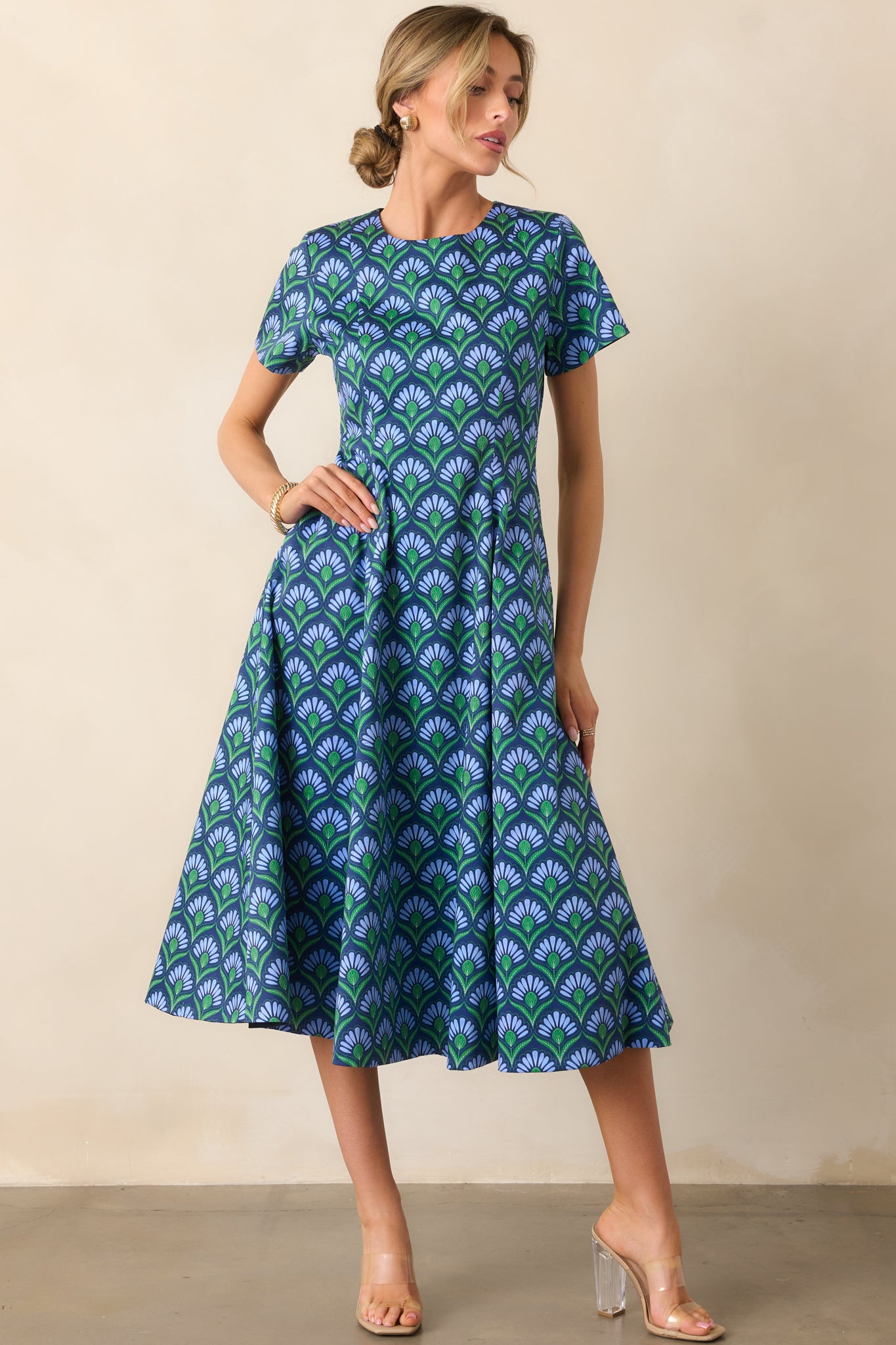 Midi dress highlighting the blue multicolor geometric print on the left side and fitted bodice.