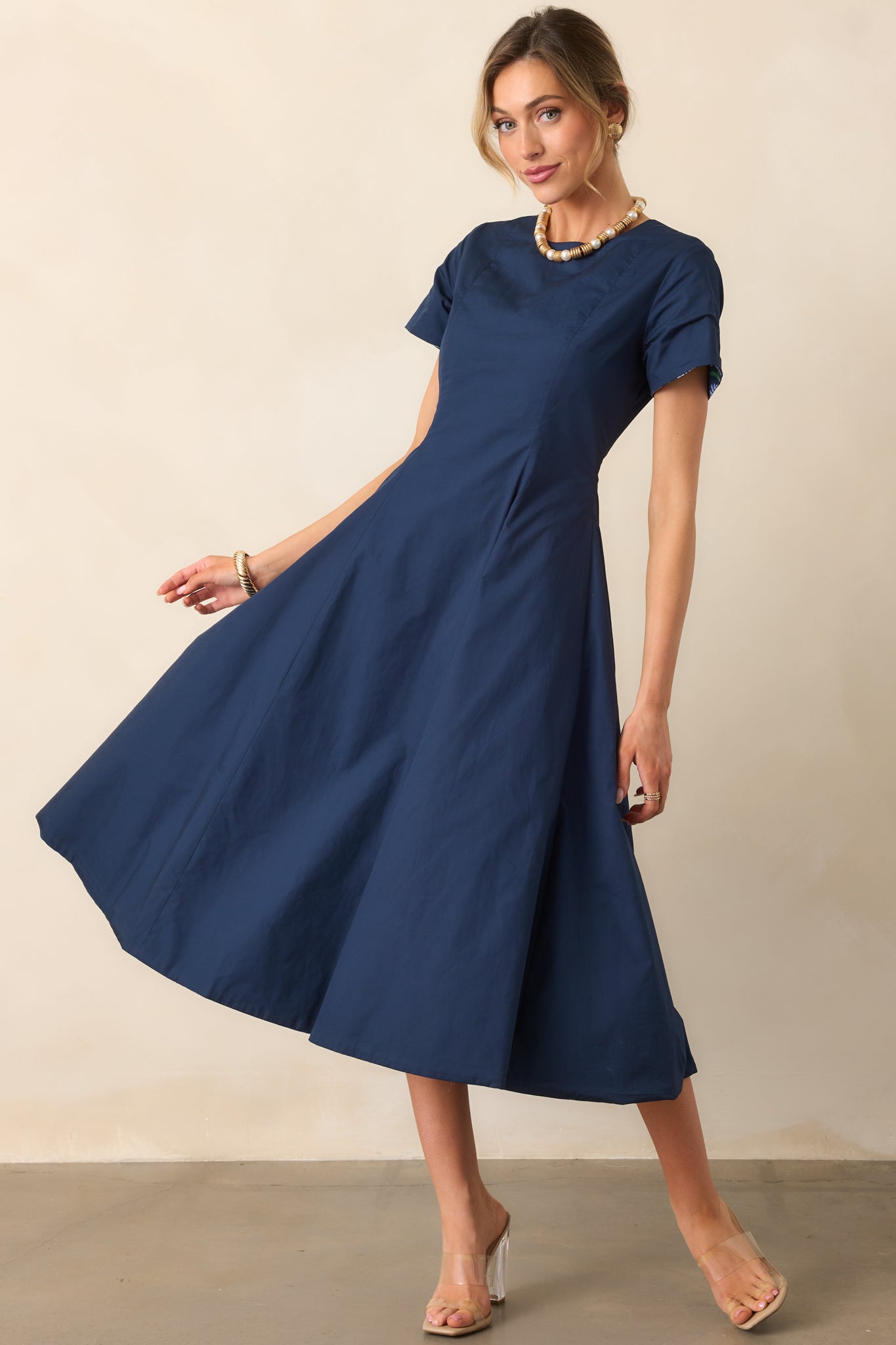 Midi dress showcasing the solid midnight blue panel on the right side and fitted bodice.