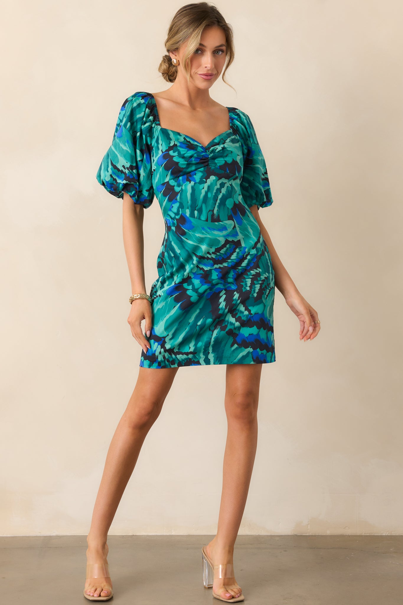 Blue abstract mini dress showcasing its ruched bust detail and softly structured design.