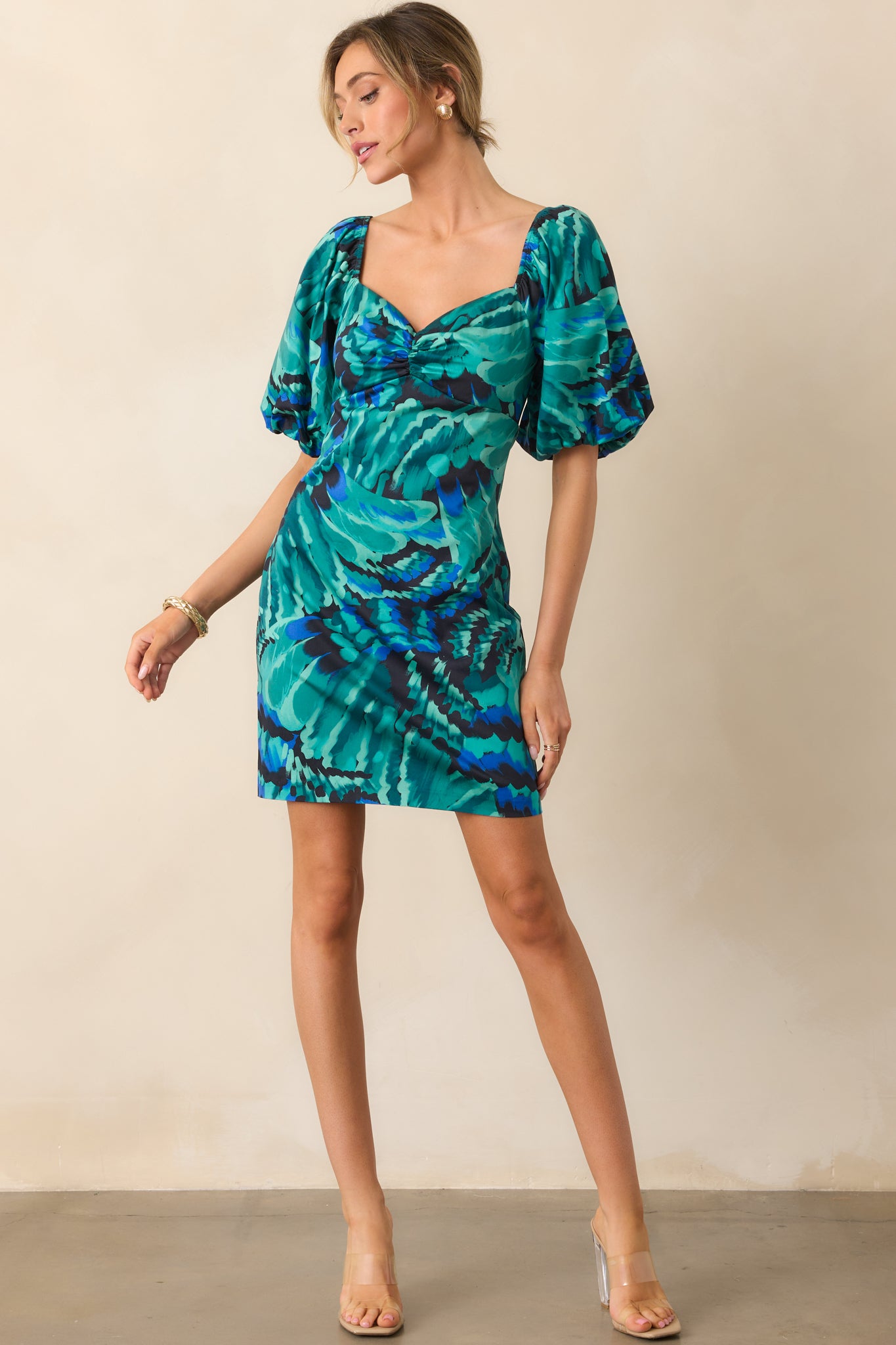 Colorful mini dress with a sweetheart neckline, elasticized sleeves, and a tailored waist for a polished look.