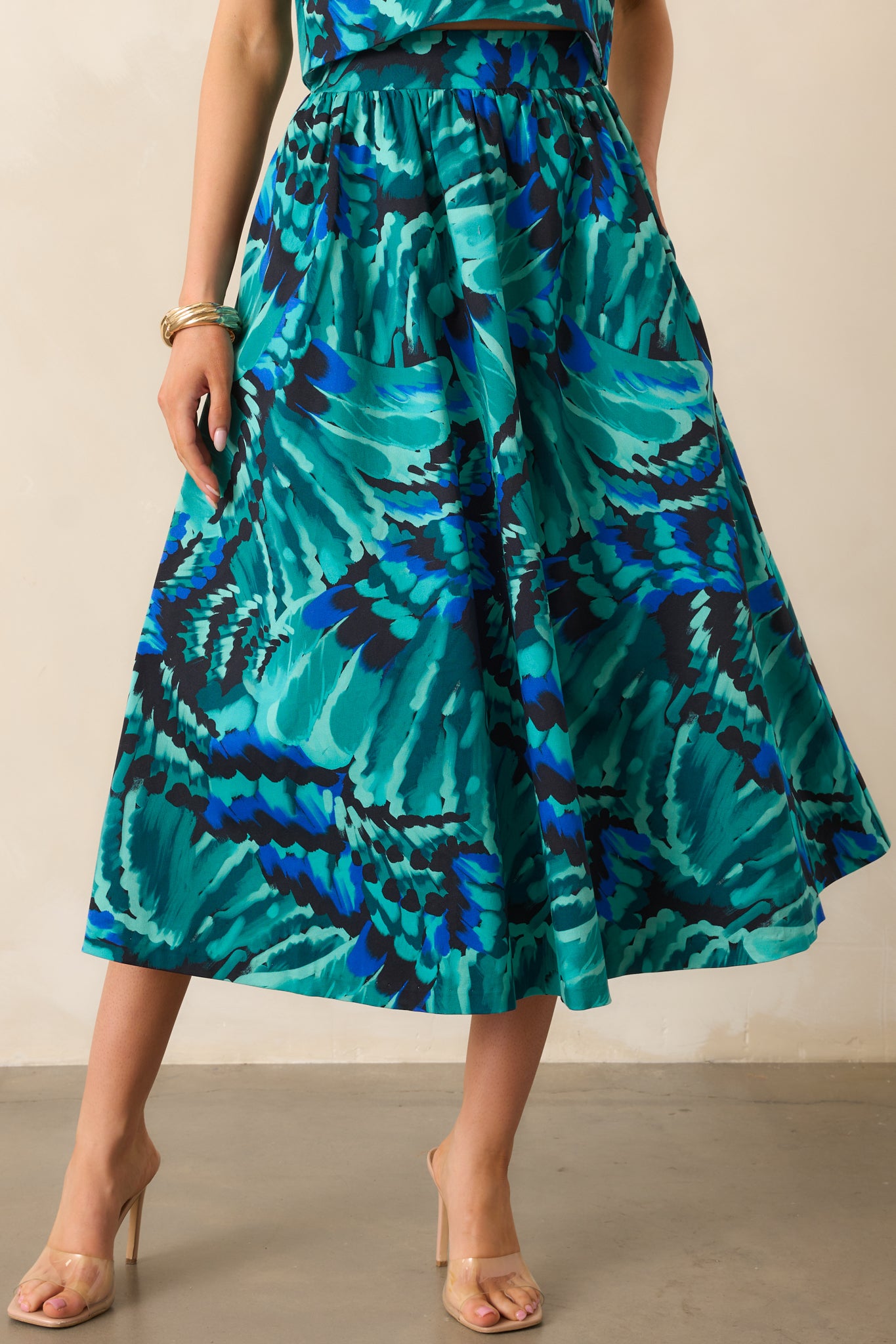 Focus on the elastic back waist insert and structured fit of the midi skirt.