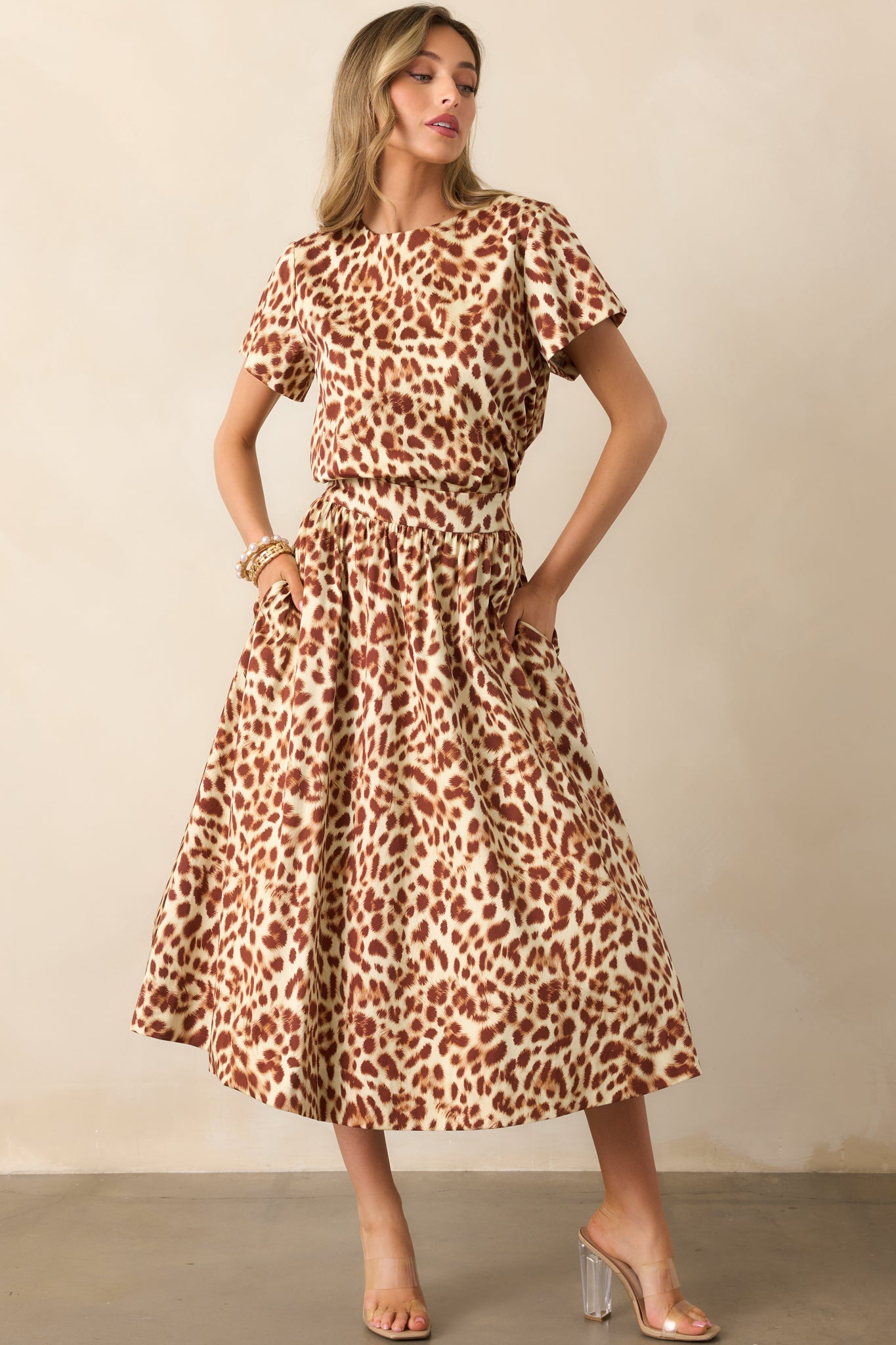 Ivory and brown leopard print top styled to showcase the boxy silhouette, short sleeves, and round neckline.