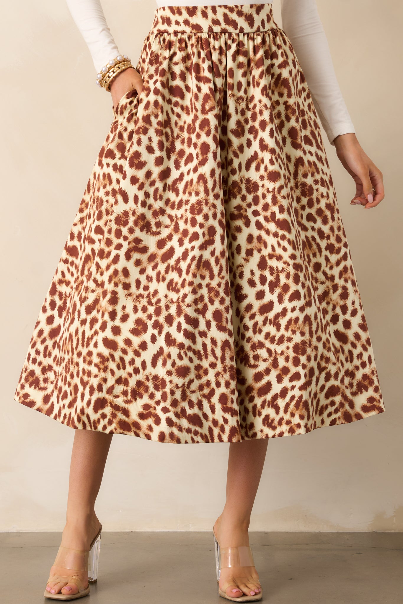 Focused view of the high-rise waistband and detailed print pattern along the skirt’s front.